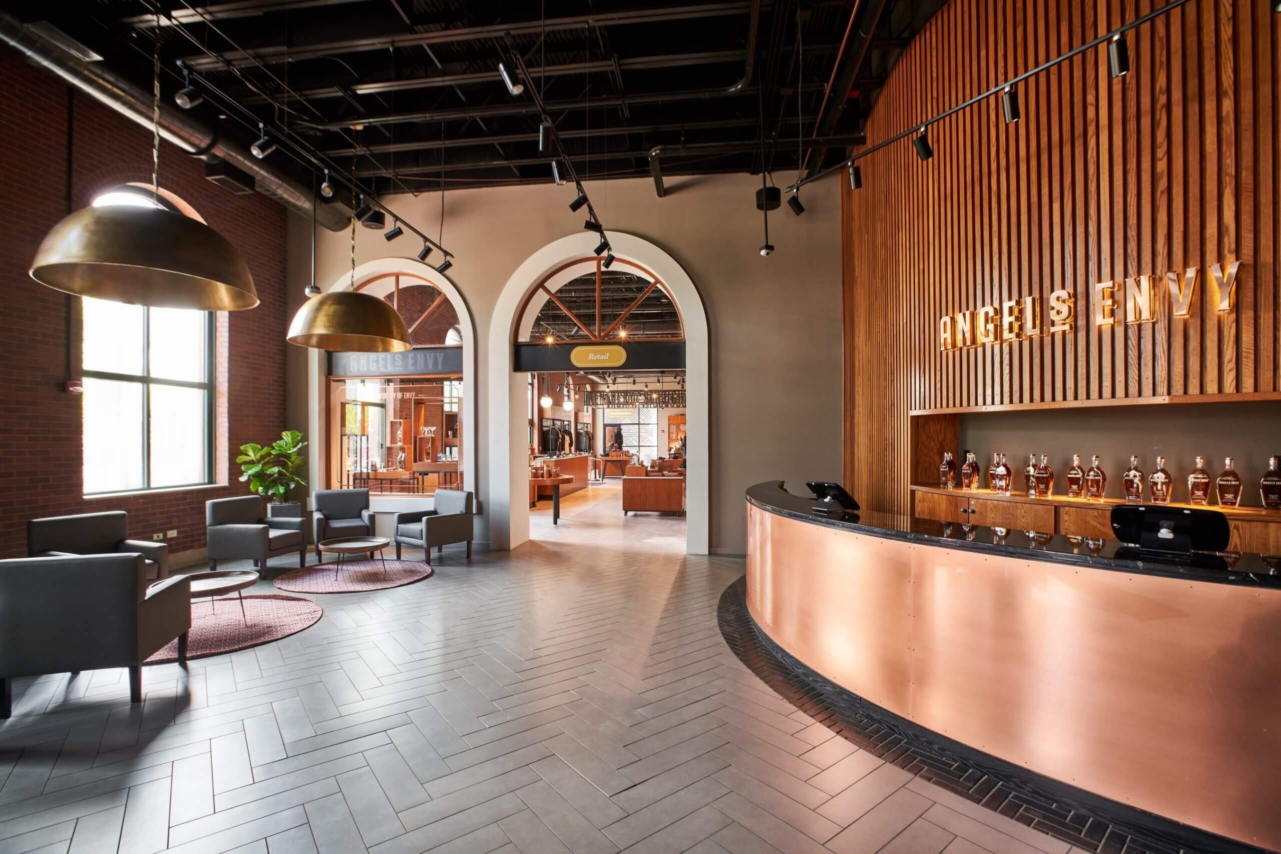 A large room with a bar and chairs.