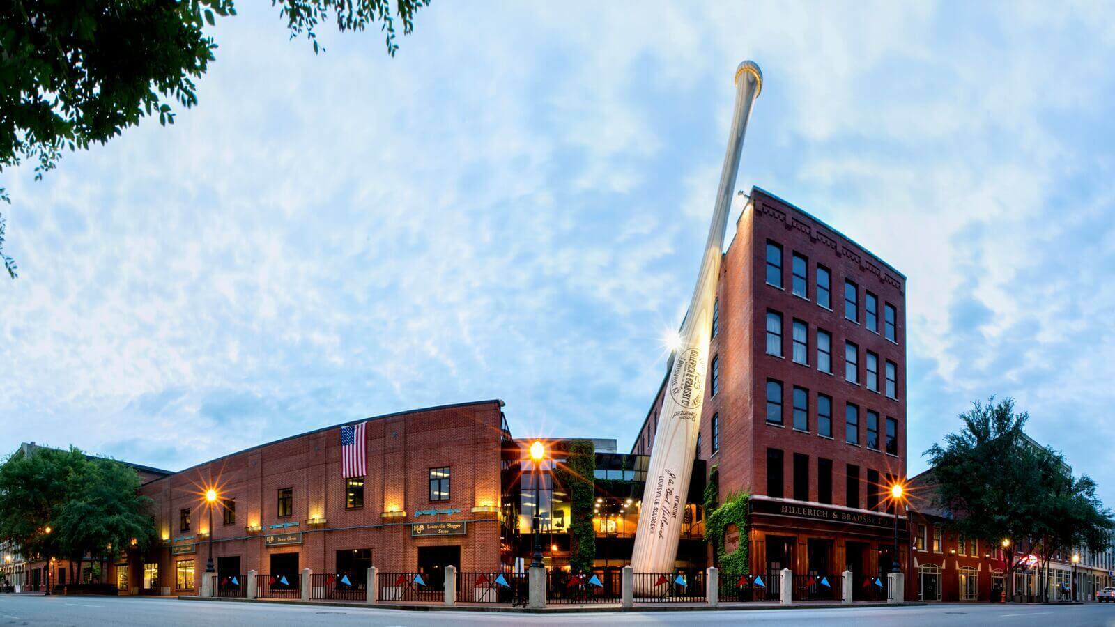 A building with a giant baseball bat in front of it.
