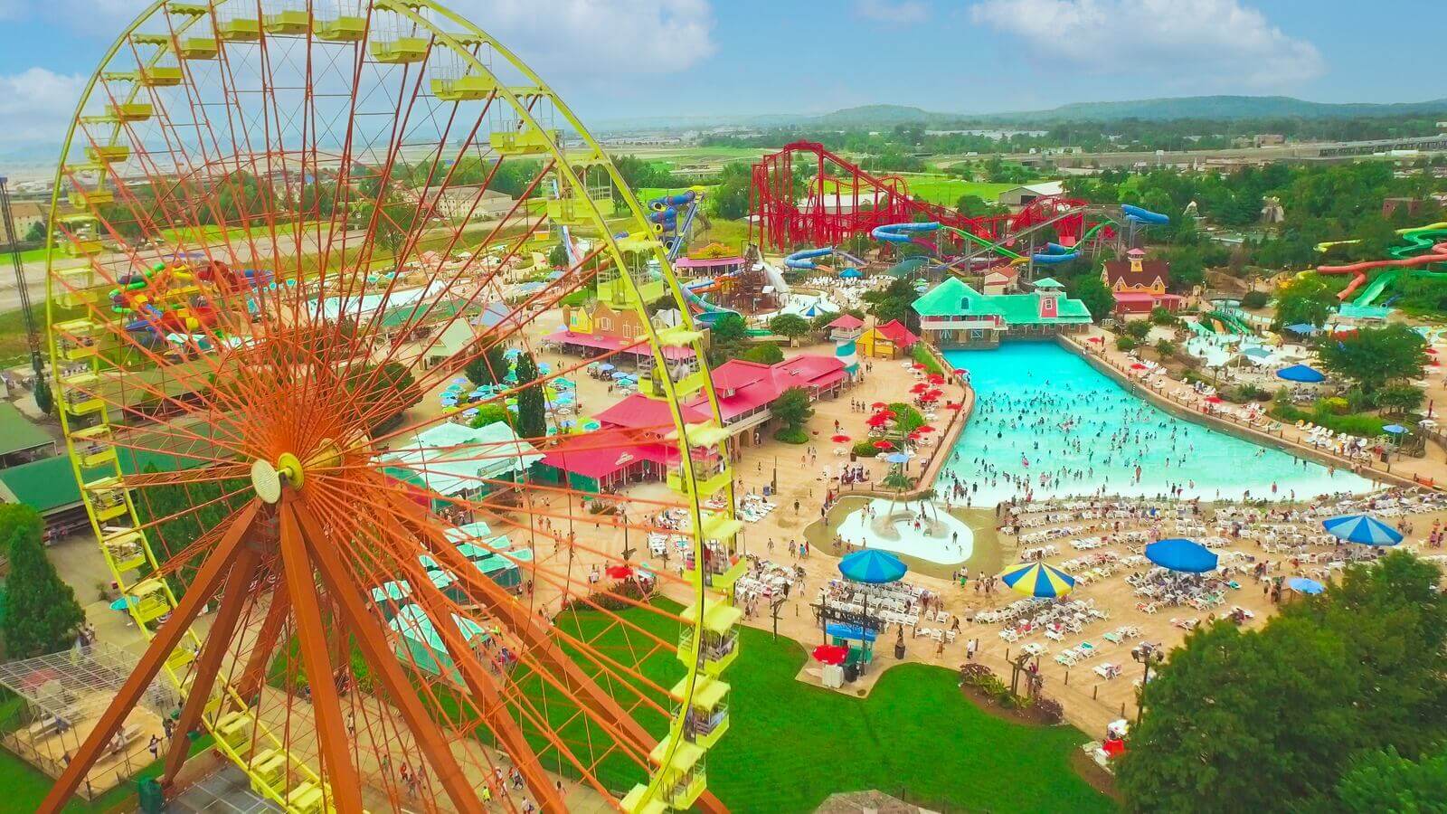An aerial view of an amusement park with a ferris wheel.