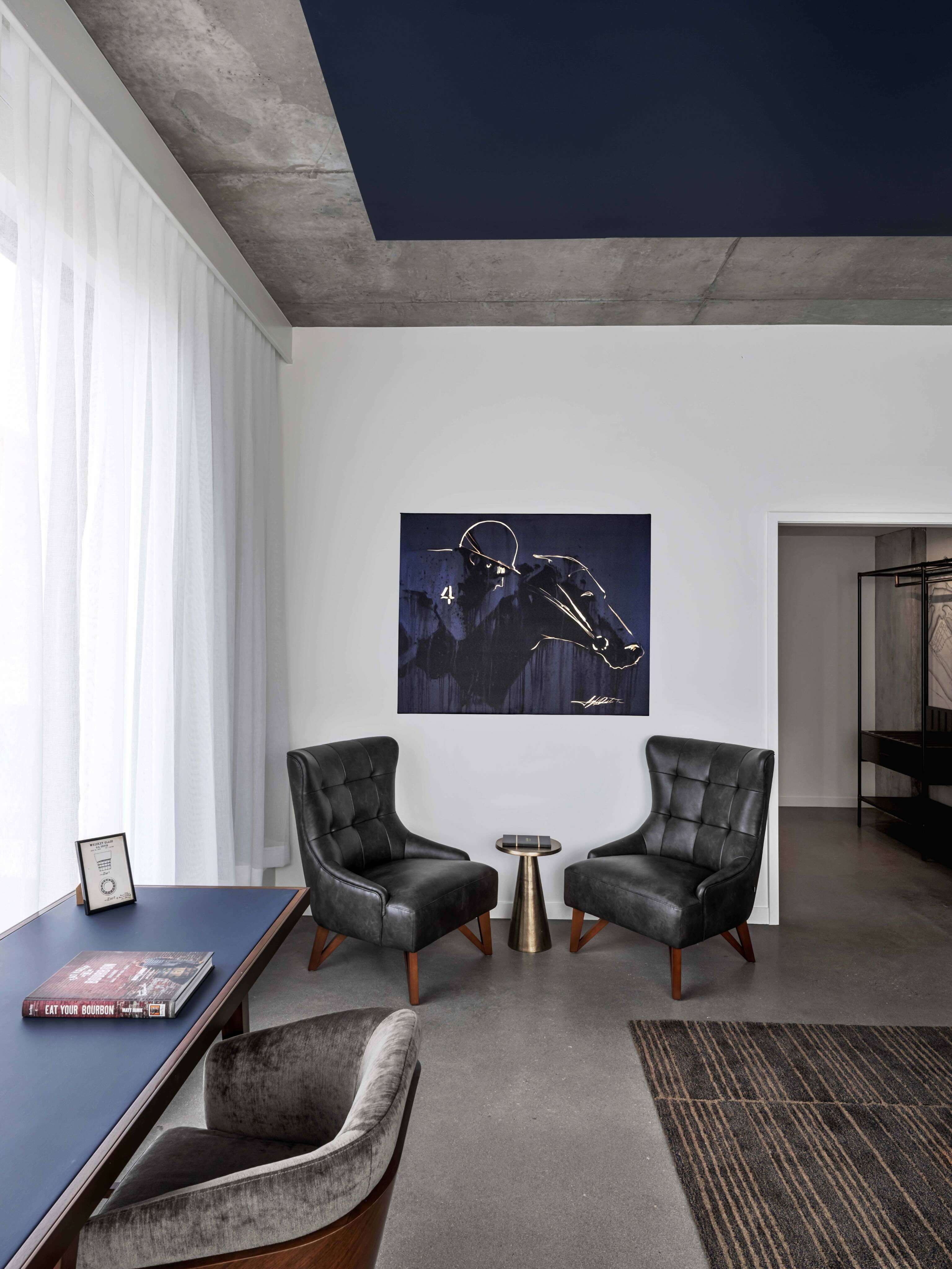 A living room with two chairs and a table.