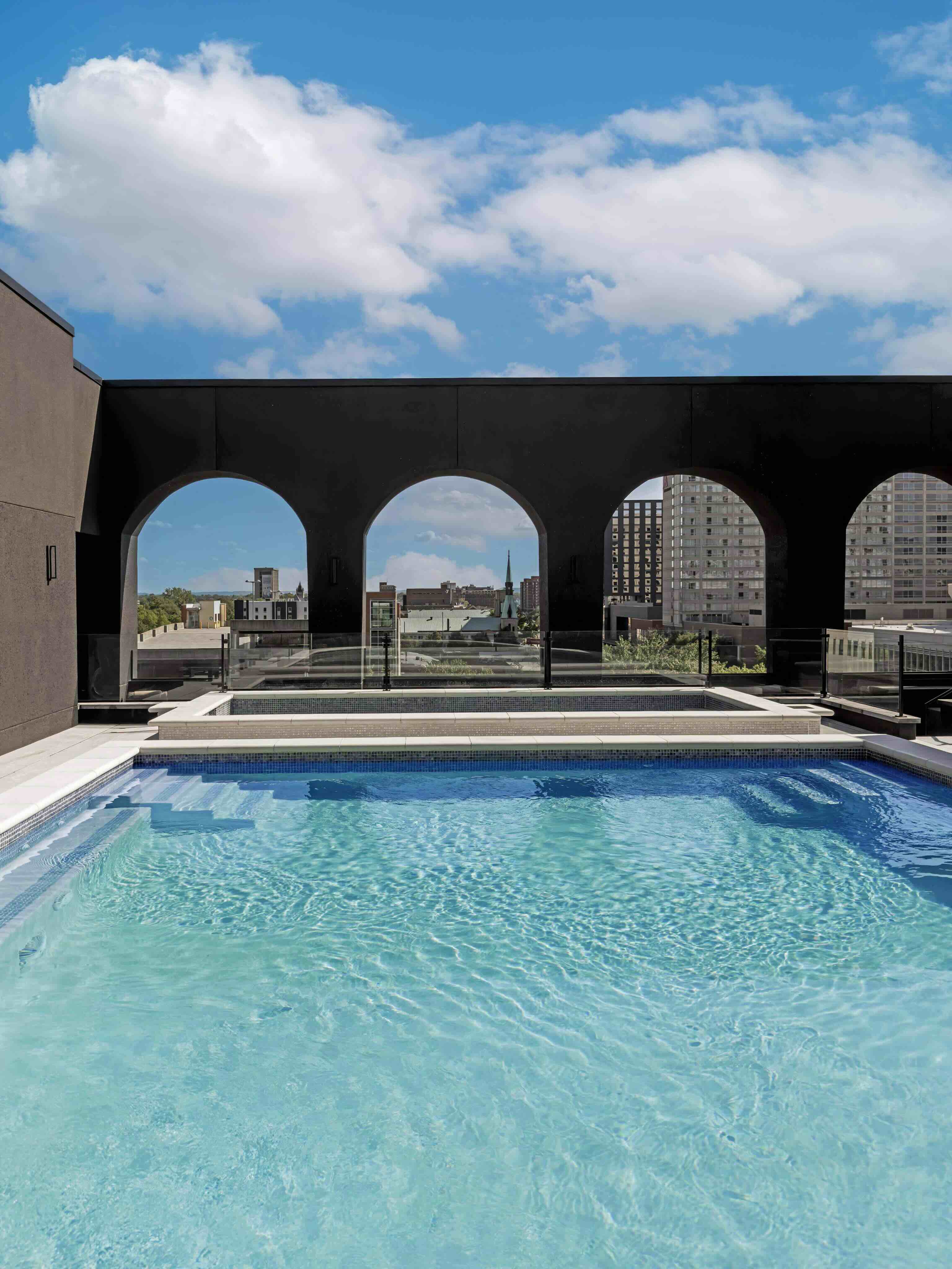 A swimming pool with a view of a city.