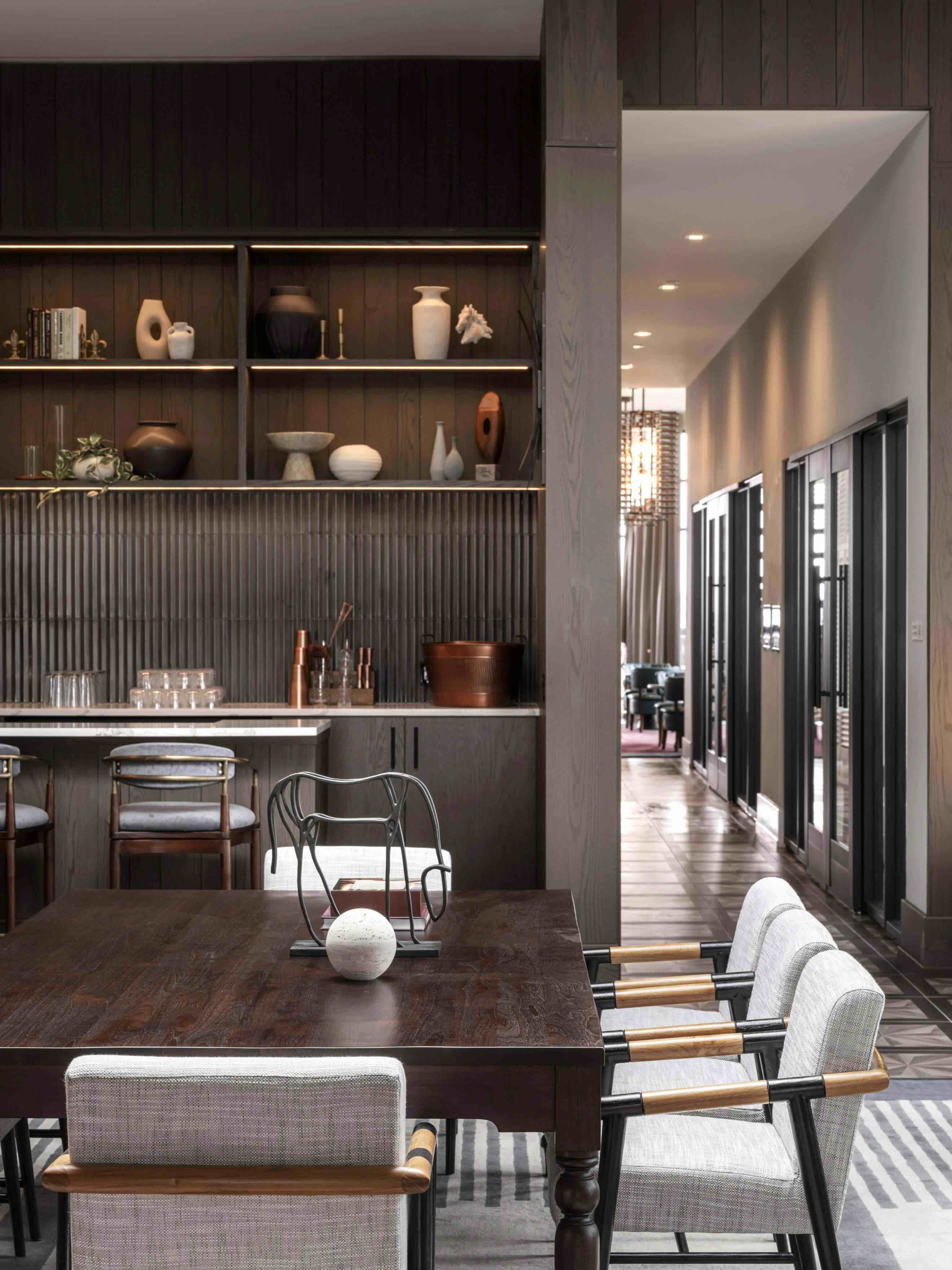 A dining room with a table and chairs.