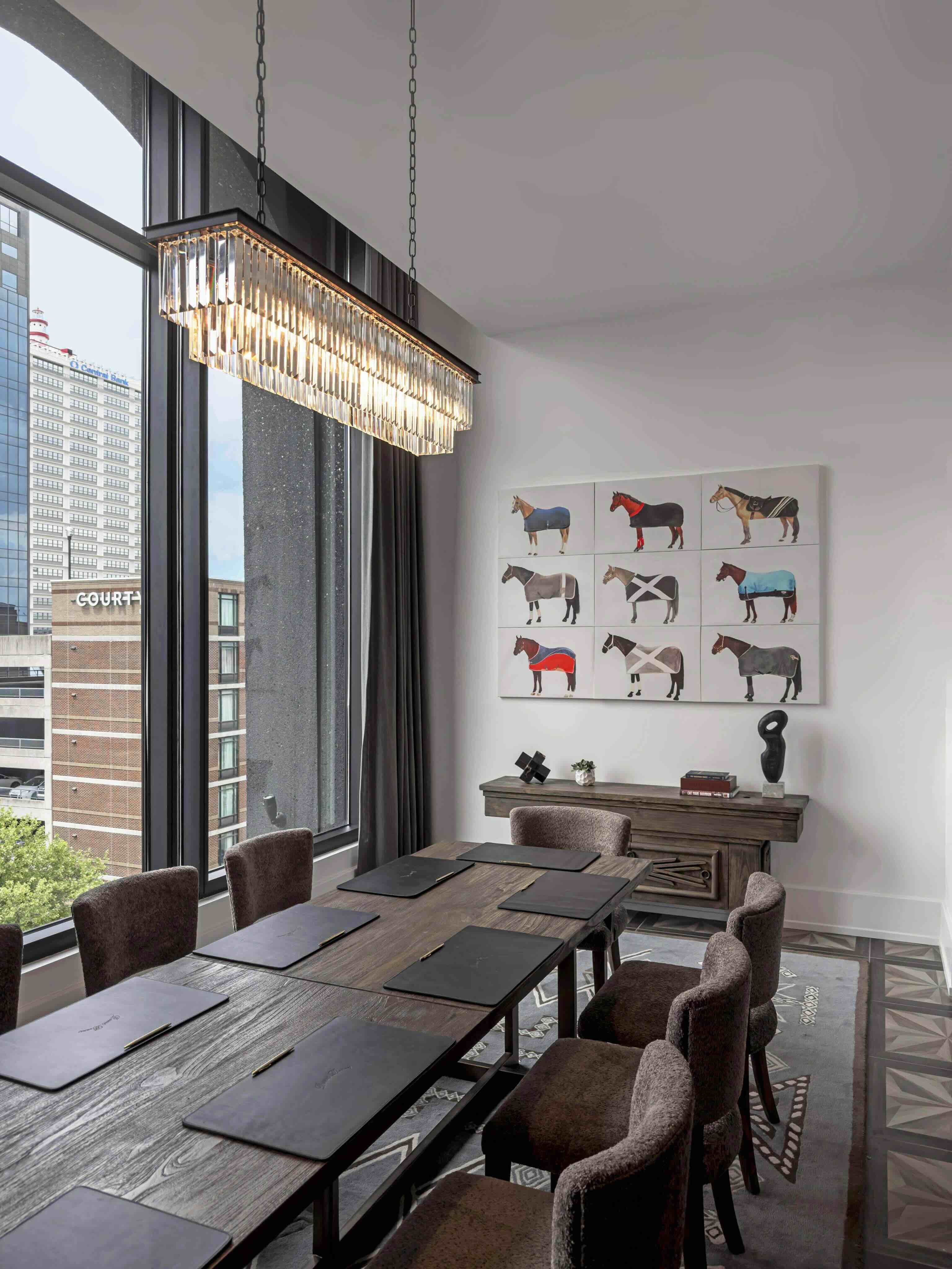 A dining room with a large table and chairs.
