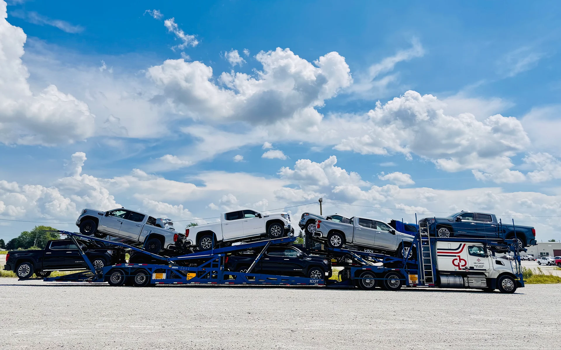 A GB Cargo's car hauling truck loaded with cars parked at a rest area.