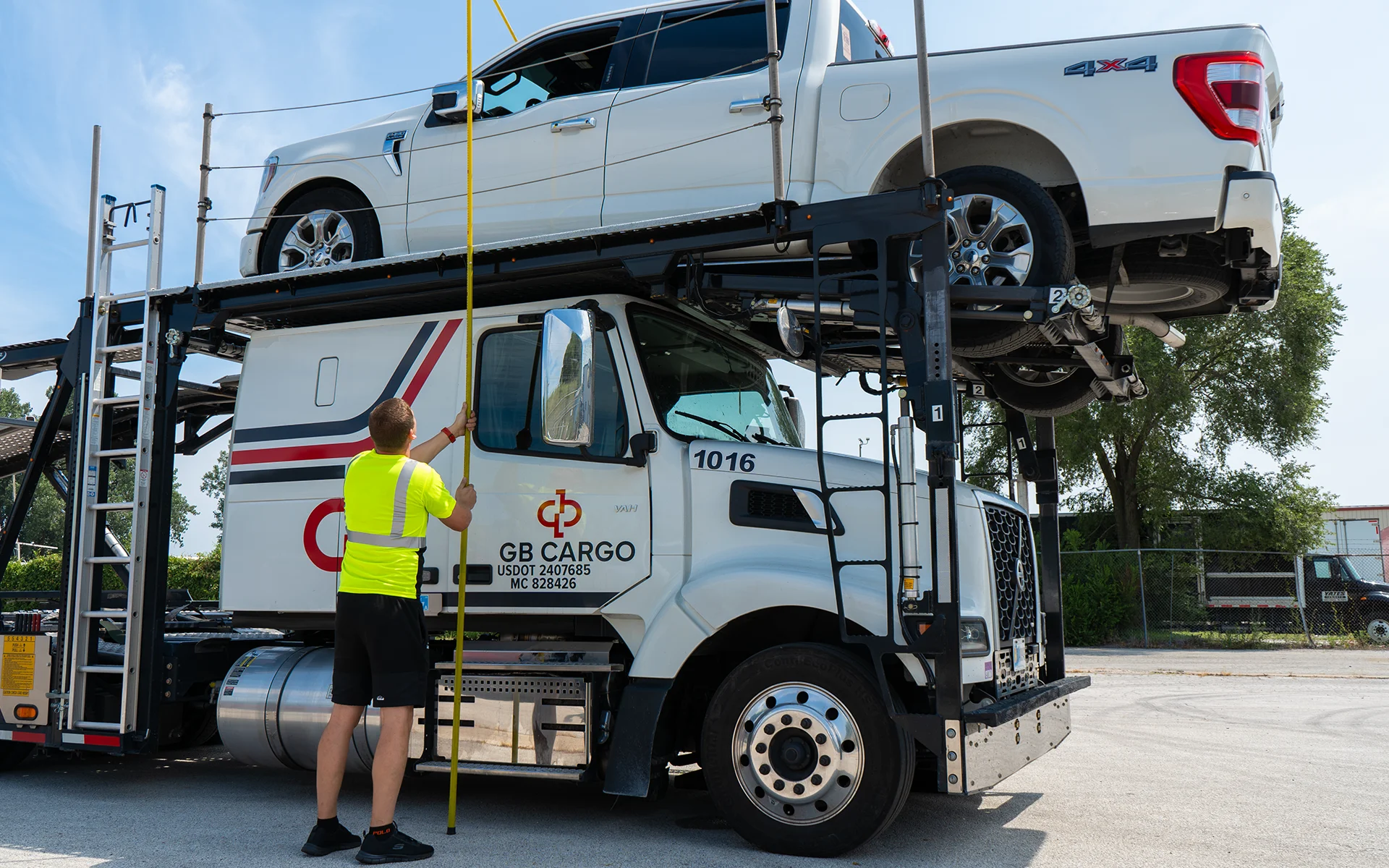 GB Cargo driver measures the hight of a loaded truck on a car hauler.