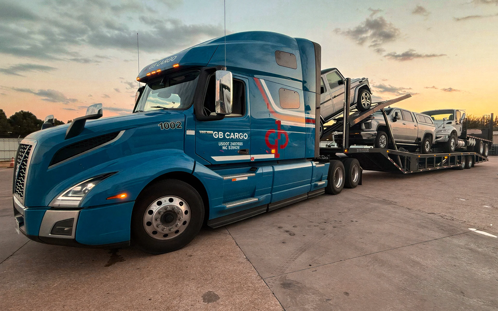 A GB Cargo car hauling truck parked at an car auction.