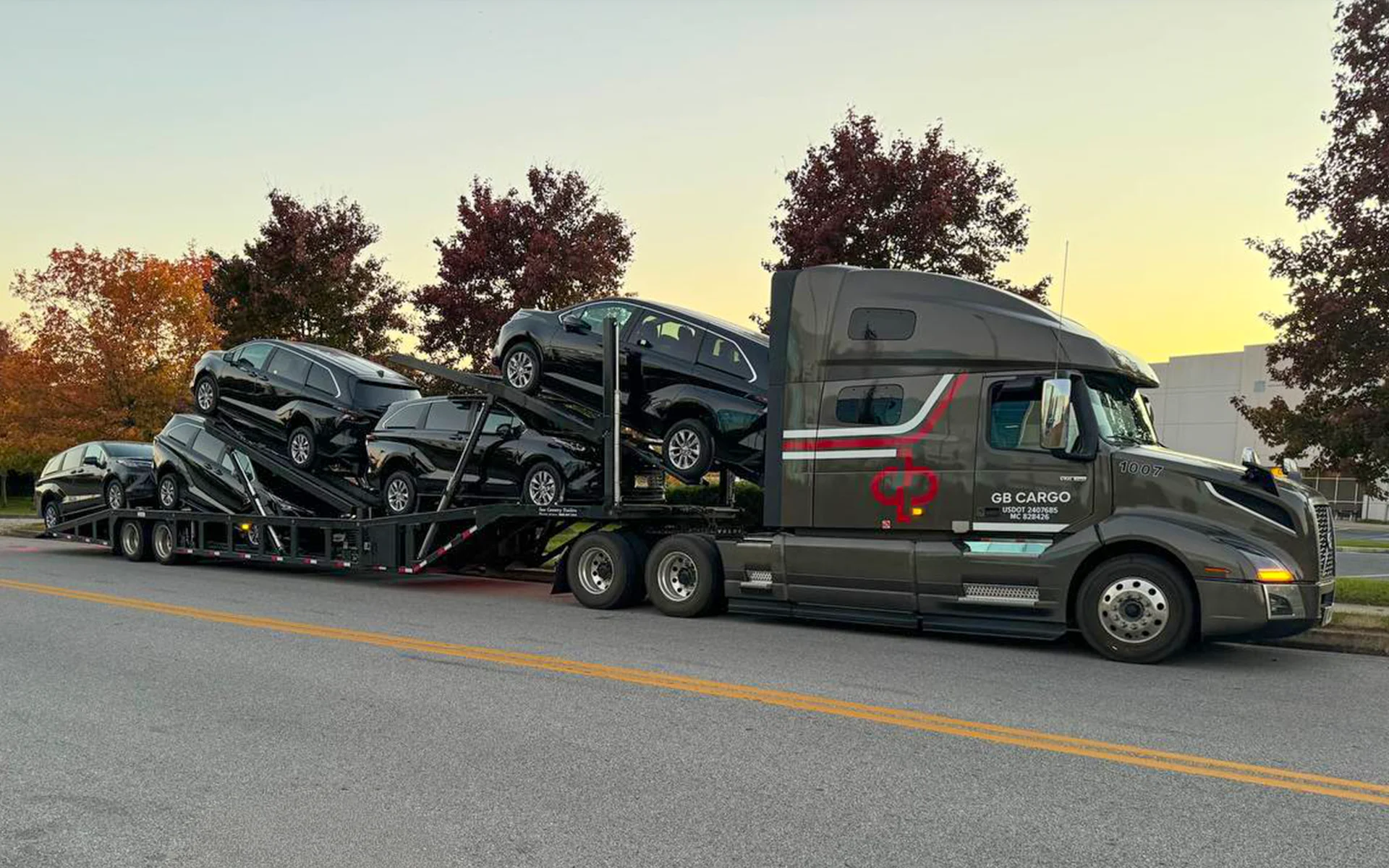 A GB Cargo car hauling truck loaded with cars.