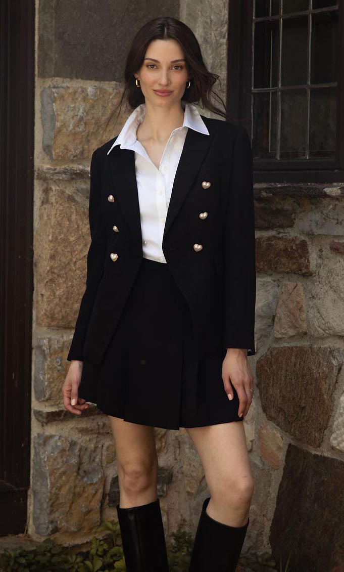 A woman wearing a white shirt and a flower necklace.
