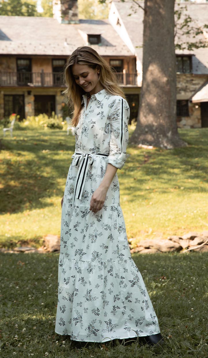 A woman wearing a black dress and a brown bow tie.