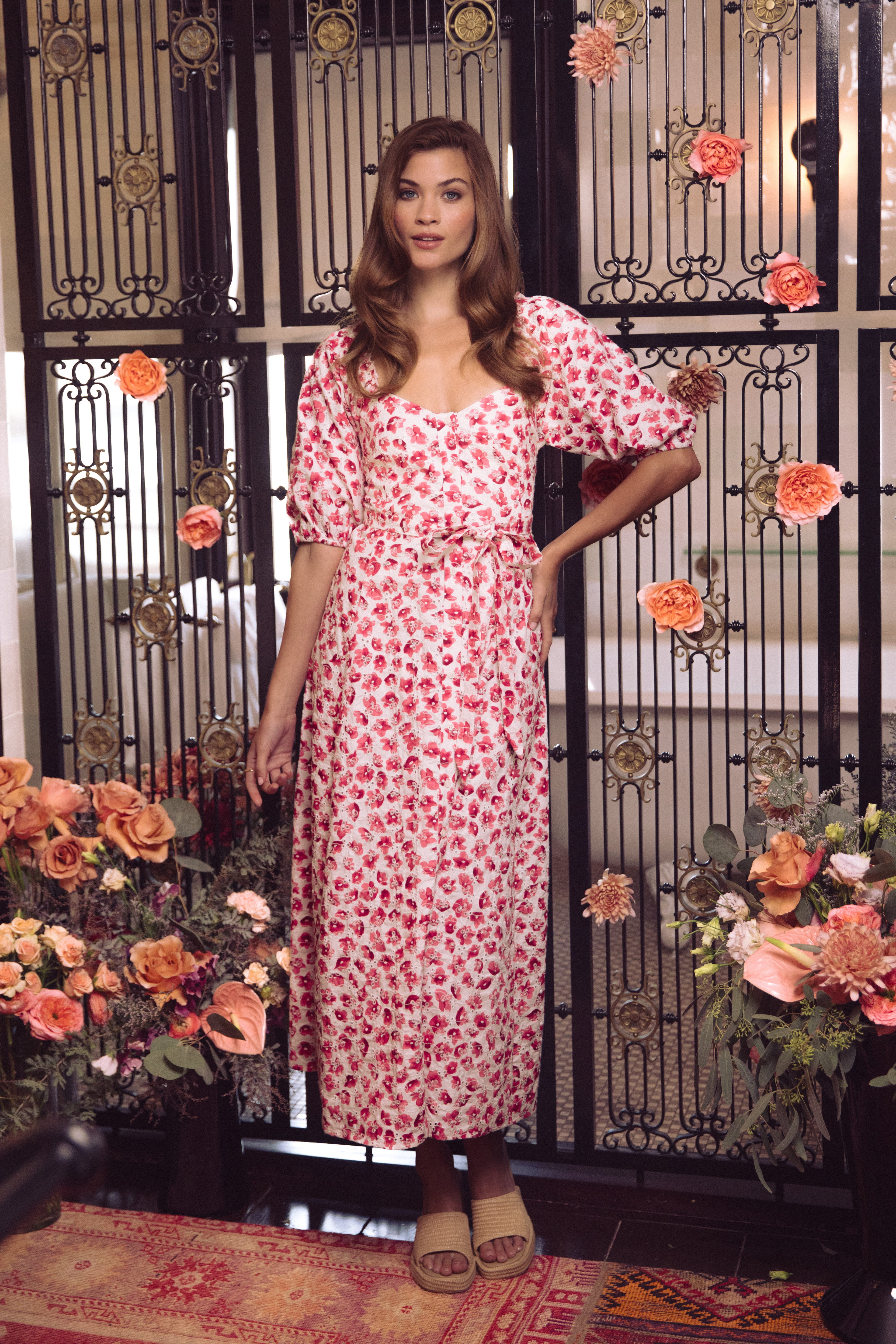 A woman wearing a black dress and a brown bow tie.