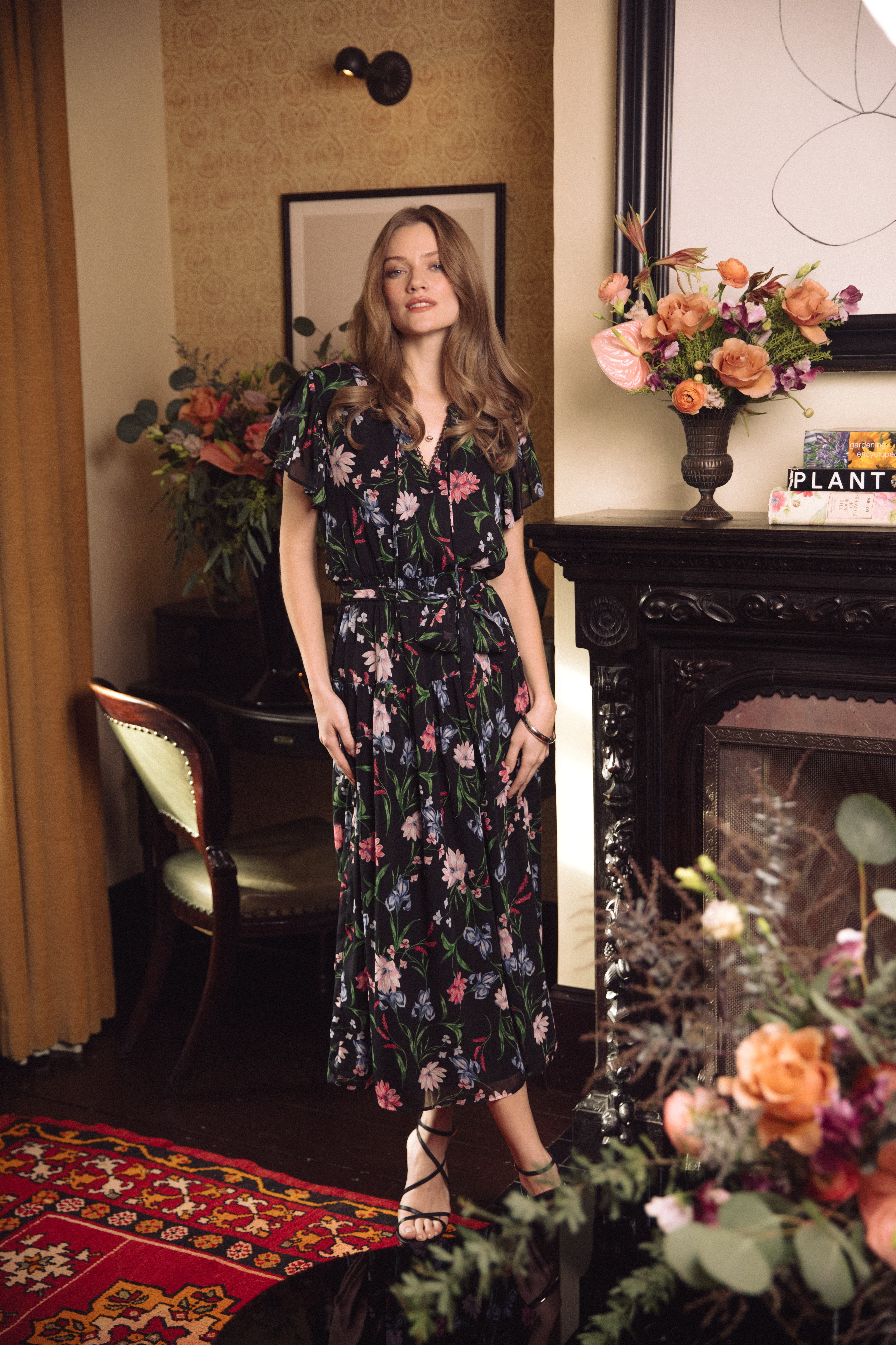 A woman wearing a white shirt and a flower necklace.