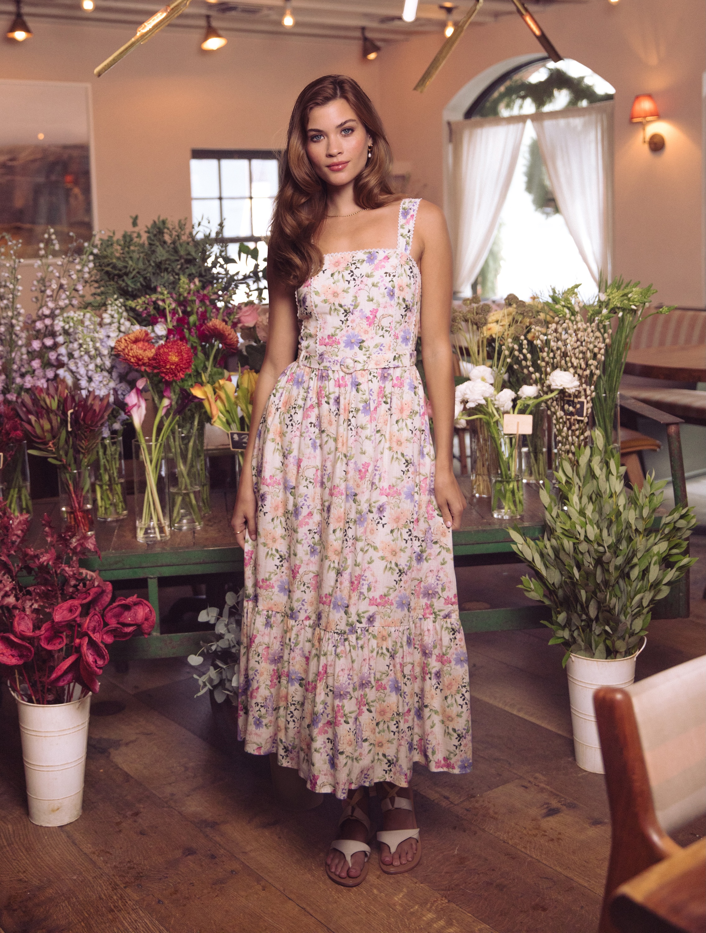 A woman standing next to a lamp post.