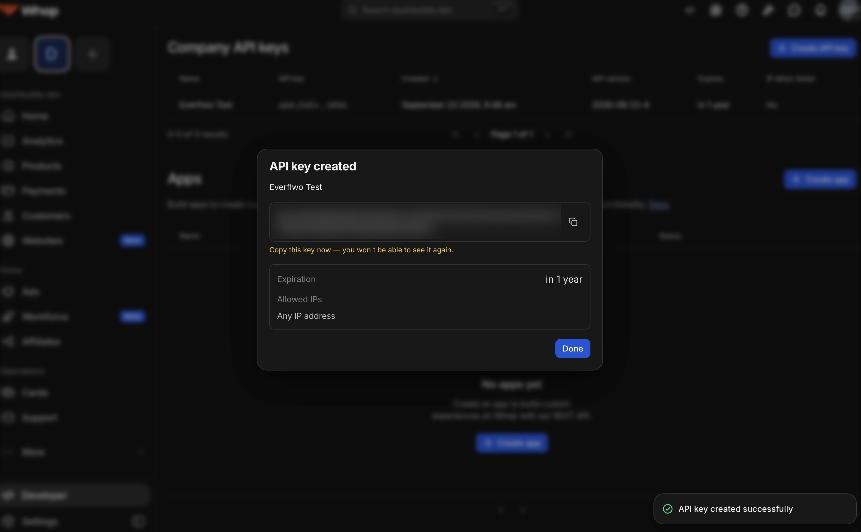 The API key created dialog, with the key value blurred and the warning that it can only be seen once