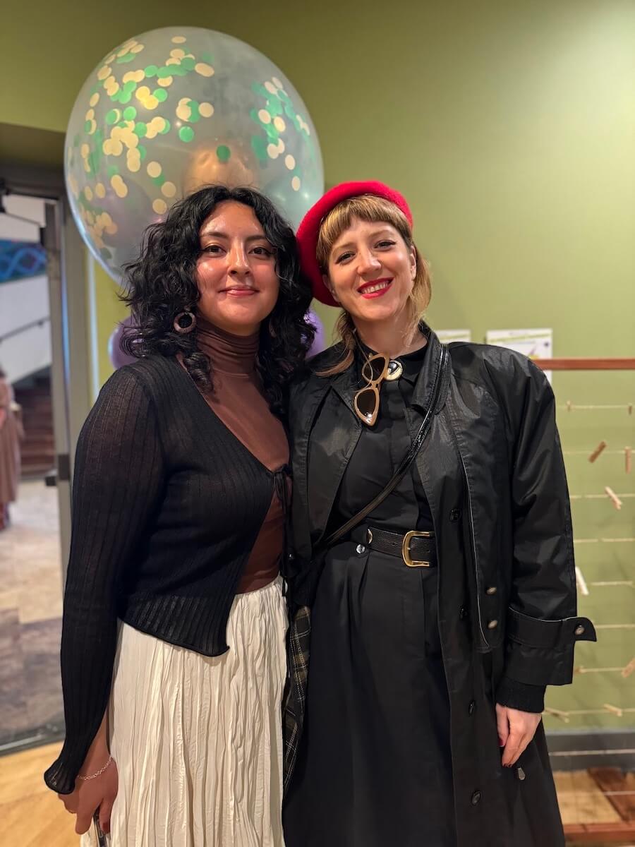Maksin Puzar and a fellow staff pose together during a community event at The Women’s Building, celebrating connection and service.