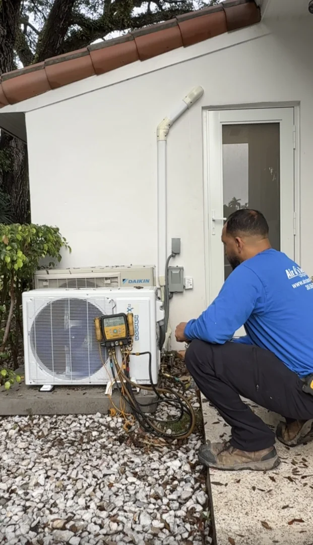 homeowner inspecting a digital thermostat in a modern Florida home homeowner inspecting a digital thermostat in a modern Florida home