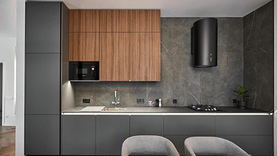 Modern kitchen with dark gray lower cabinets, wooden upper cabinets, a black range hood, gas stove, and a stainless steel sink.