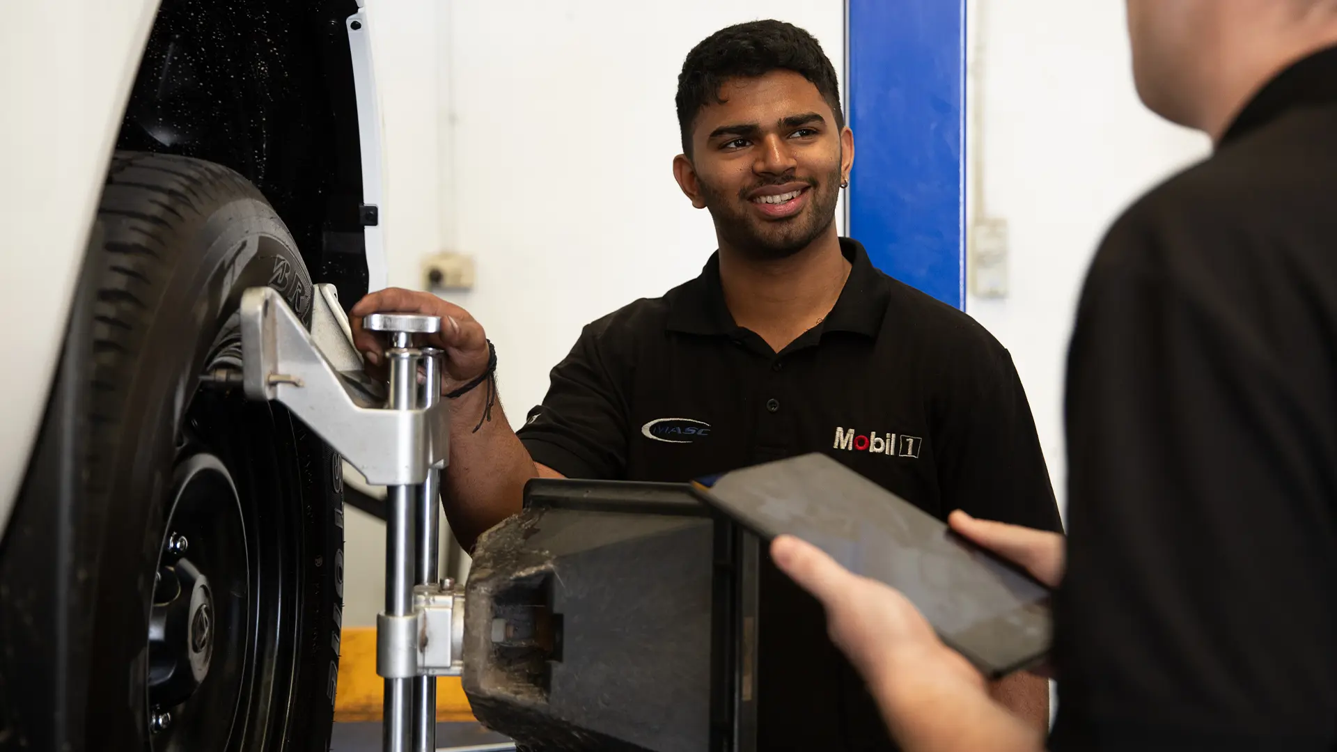 MASC technician talking a customer through the work on their vehicle