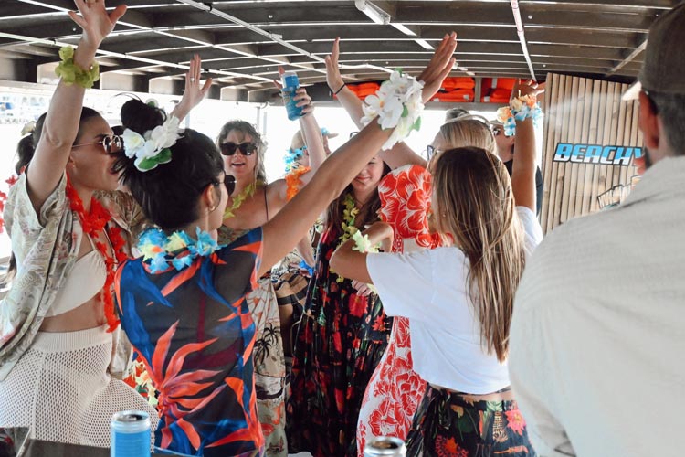 Guests dancing on The Beachy Tiki boat during a cruise in Ocean City, NJ
