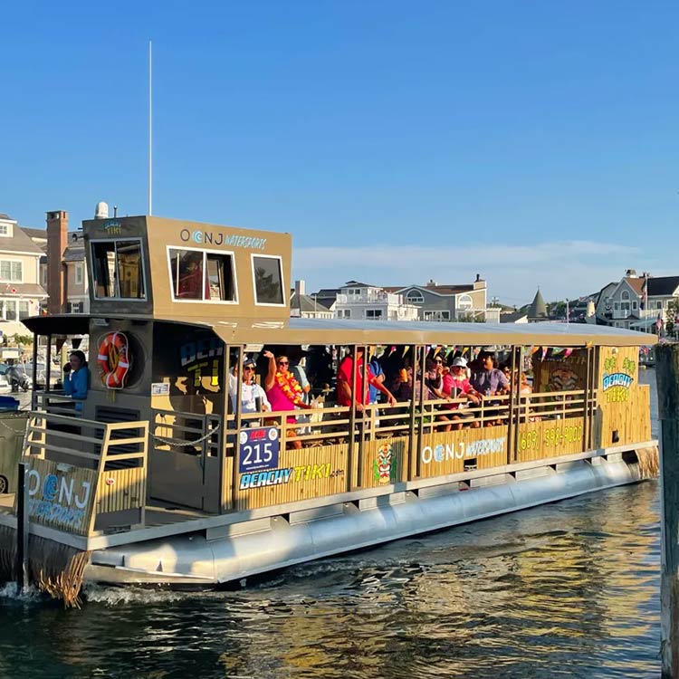 Big Beachy Tiki boat cruising the back bays with guests aboard in Ocean City, NJ