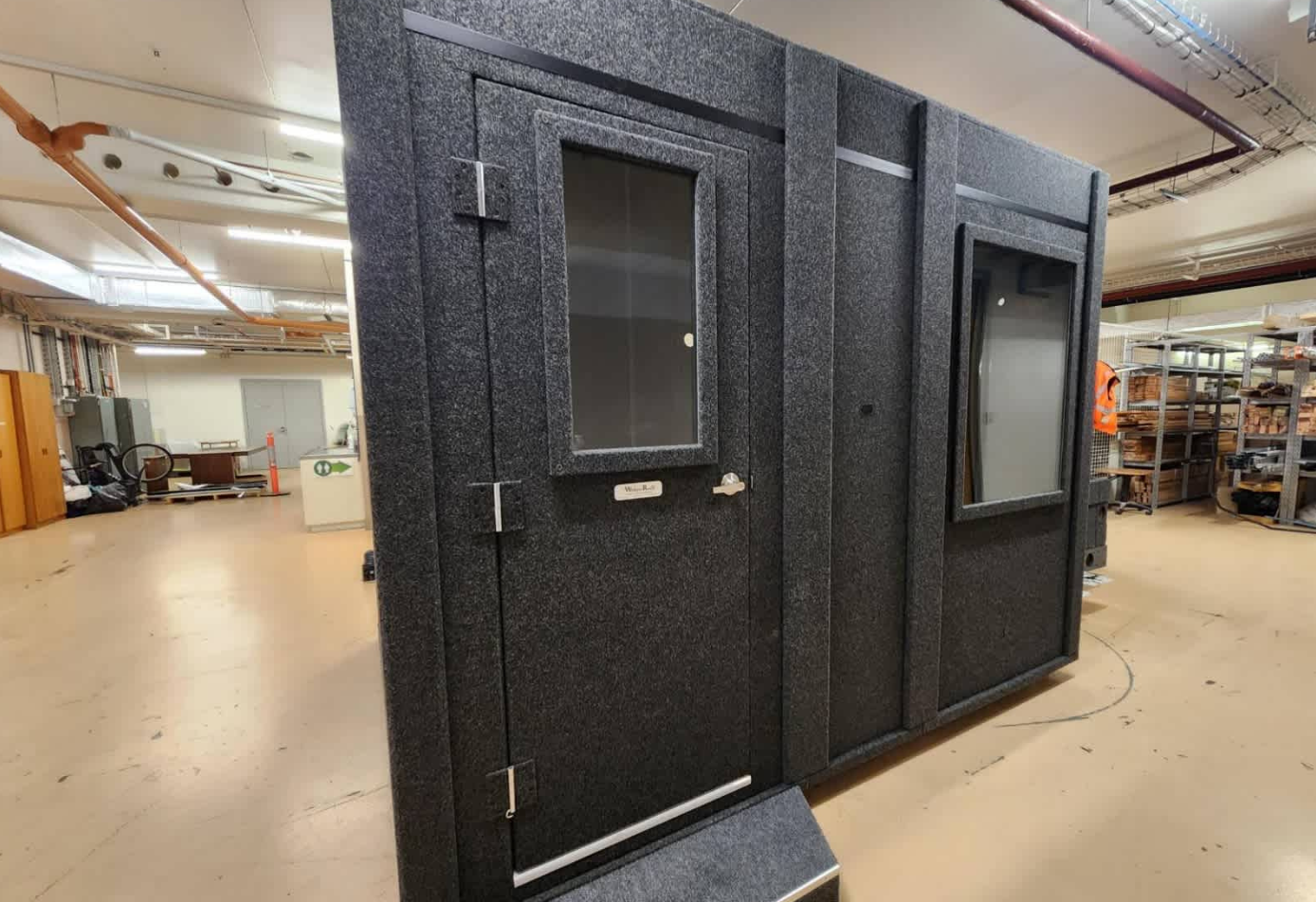 WhisperRoom 96120 S single-wall sound booth with caster plate and height extension, featuring door and wall windows.