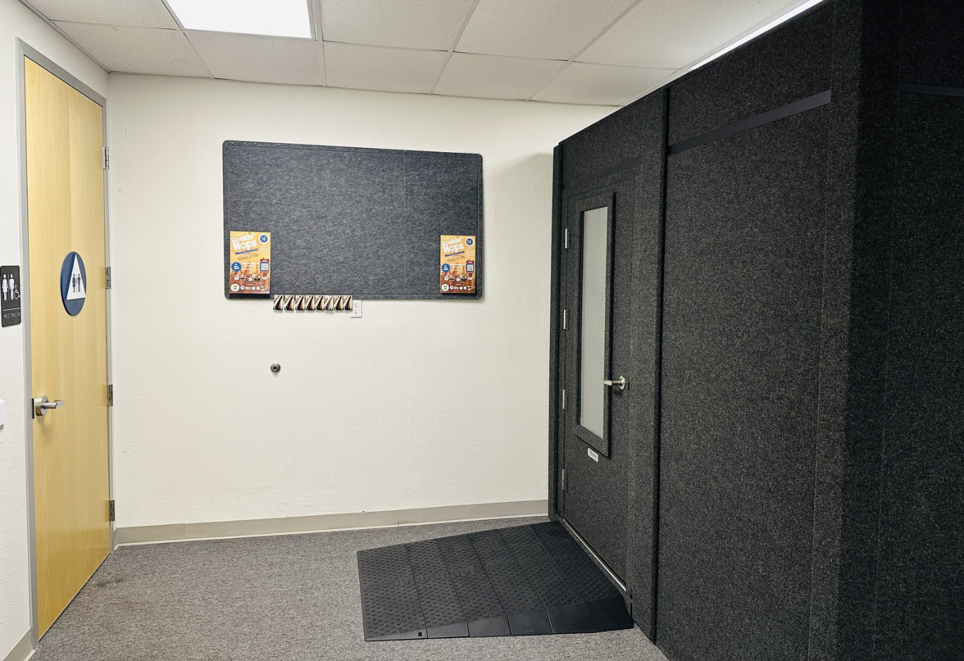 Exterior of WhisperRoom 96120 S single-wall sound booth with height extension and ADA accessibility package, including wide-access door and wheelchair ramp.
