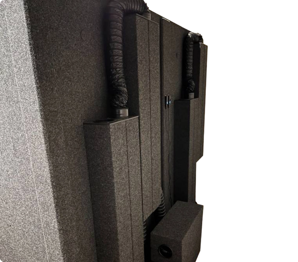 WhisperRoom ventilation system with VSS and EFS components on the exterior of a sound isolation booth for quiet airflow during recording.
