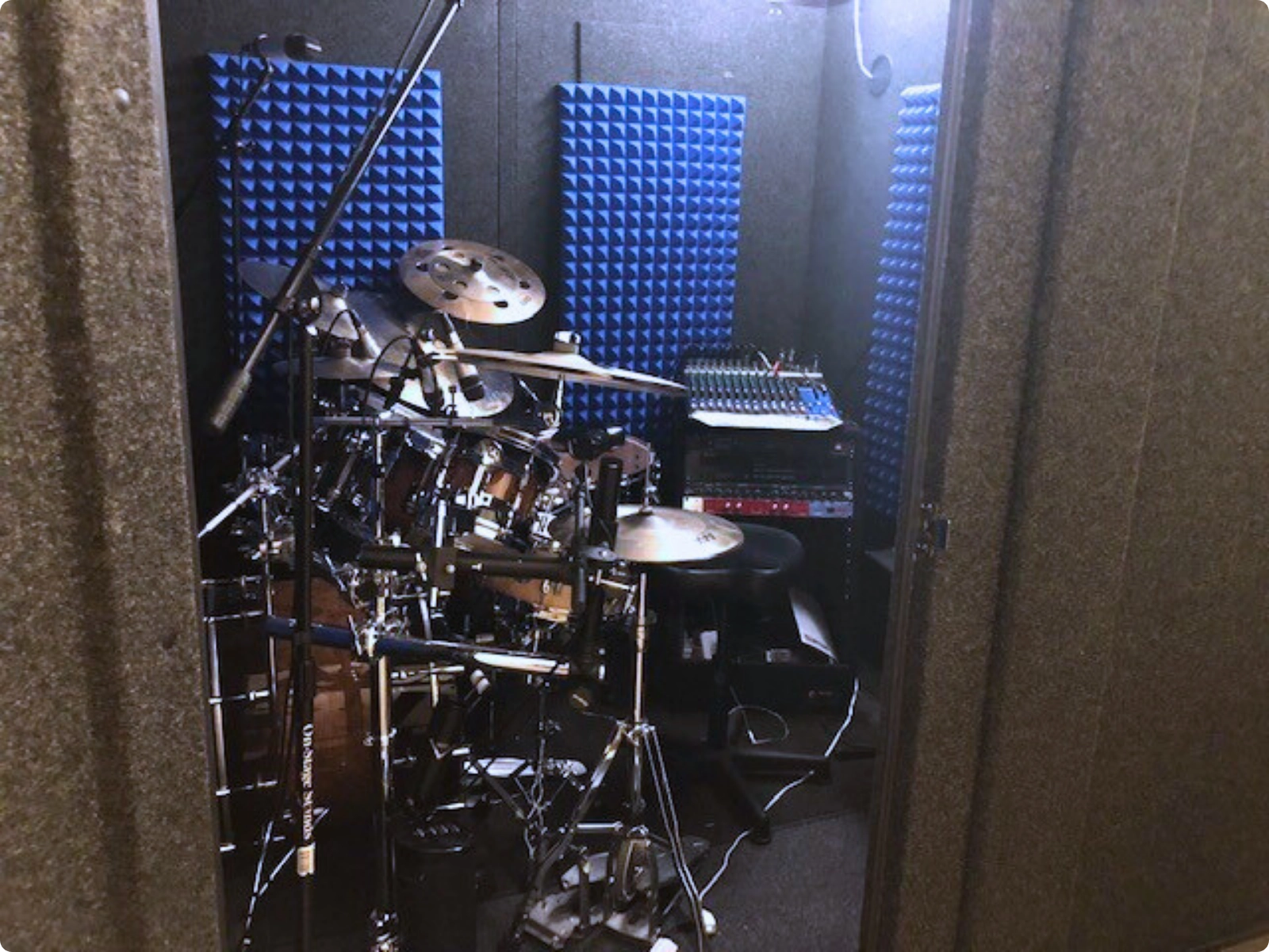 Spacious WhisperRoom drum booth with full kit setup and blue acoustic treatment.