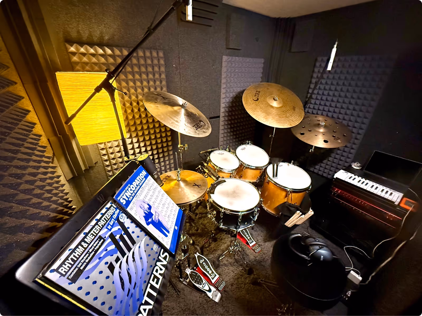 Fully equipped WhisperRoom rehearsal booth with drum kit, amps, and long-term acoustic treatment.