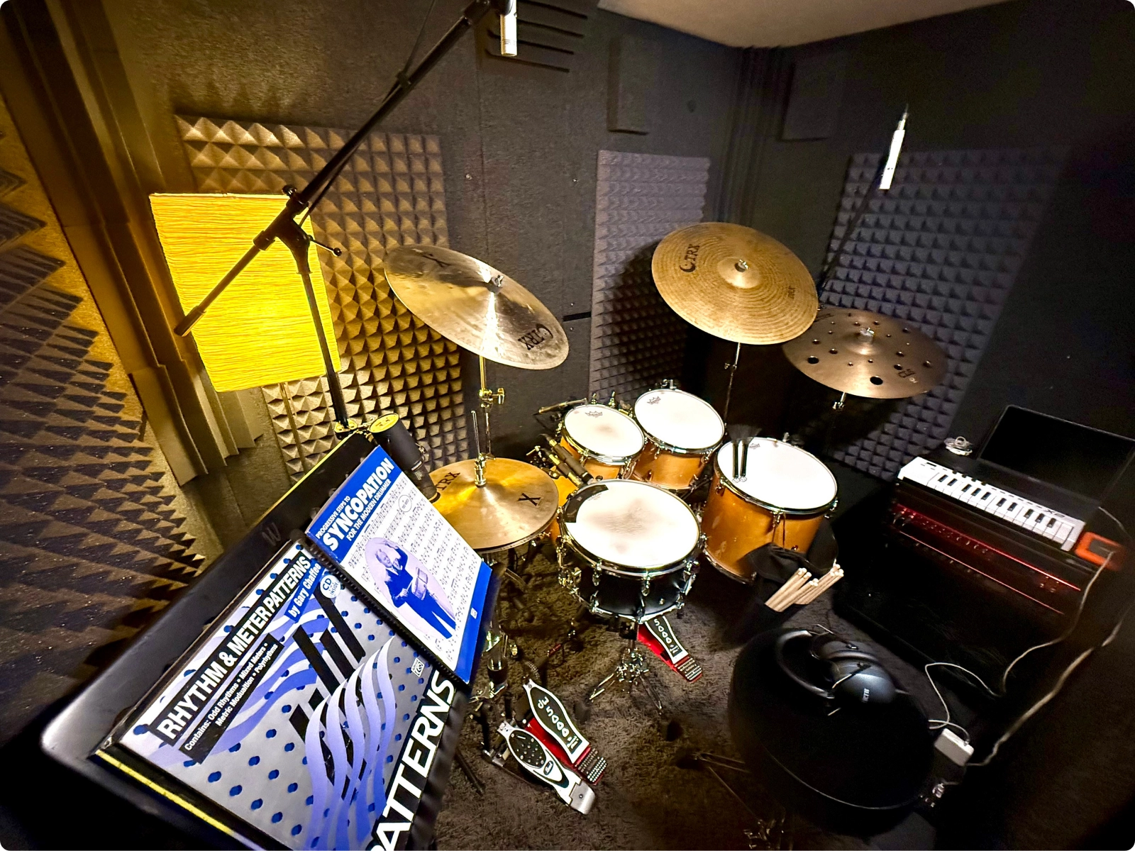 Fully equipped WhisperRoom rehearsal booth with drum kit, amps, and long-term acoustic treatment.