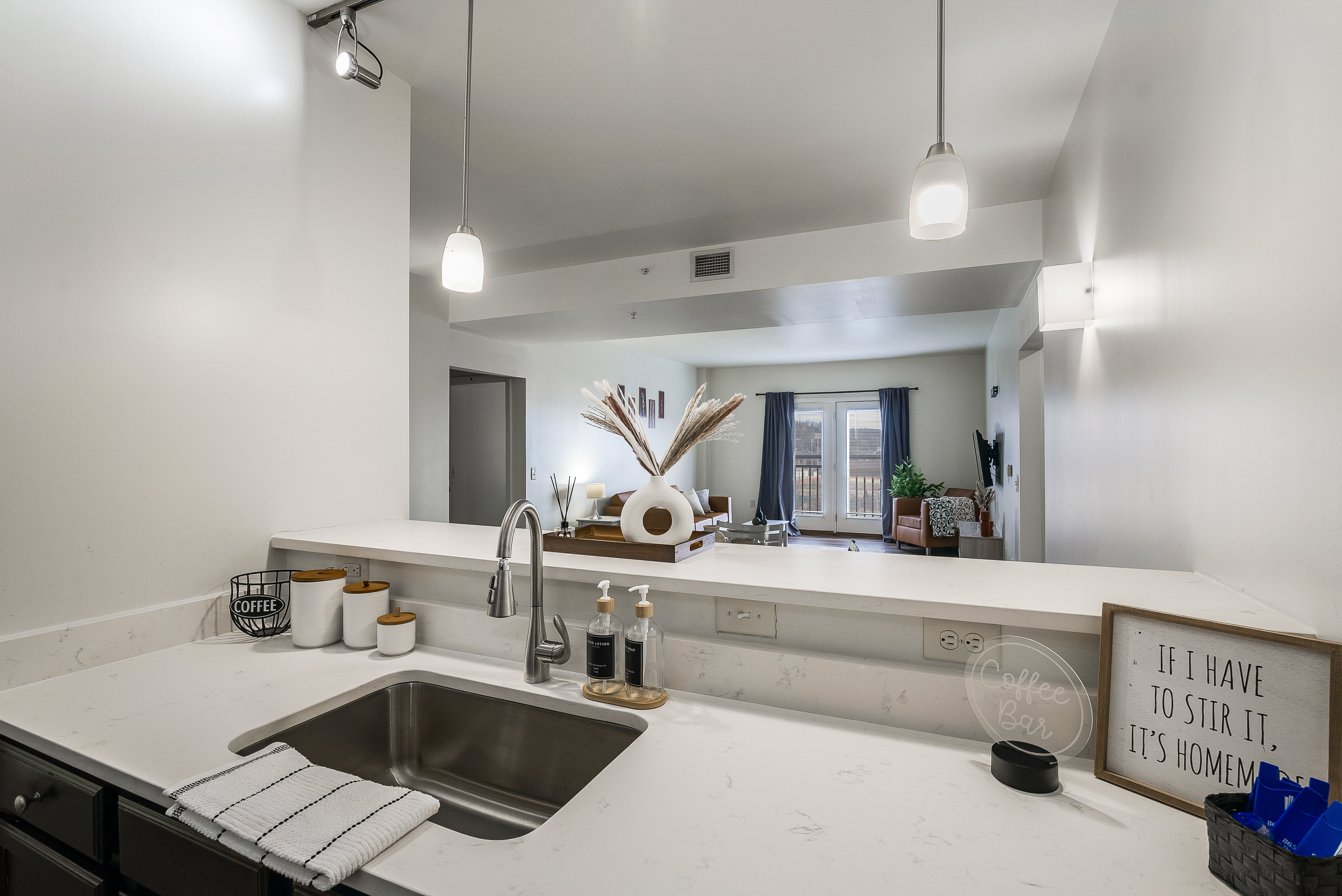 Dining room with table and chairs with view of living room with sofa and coffee table