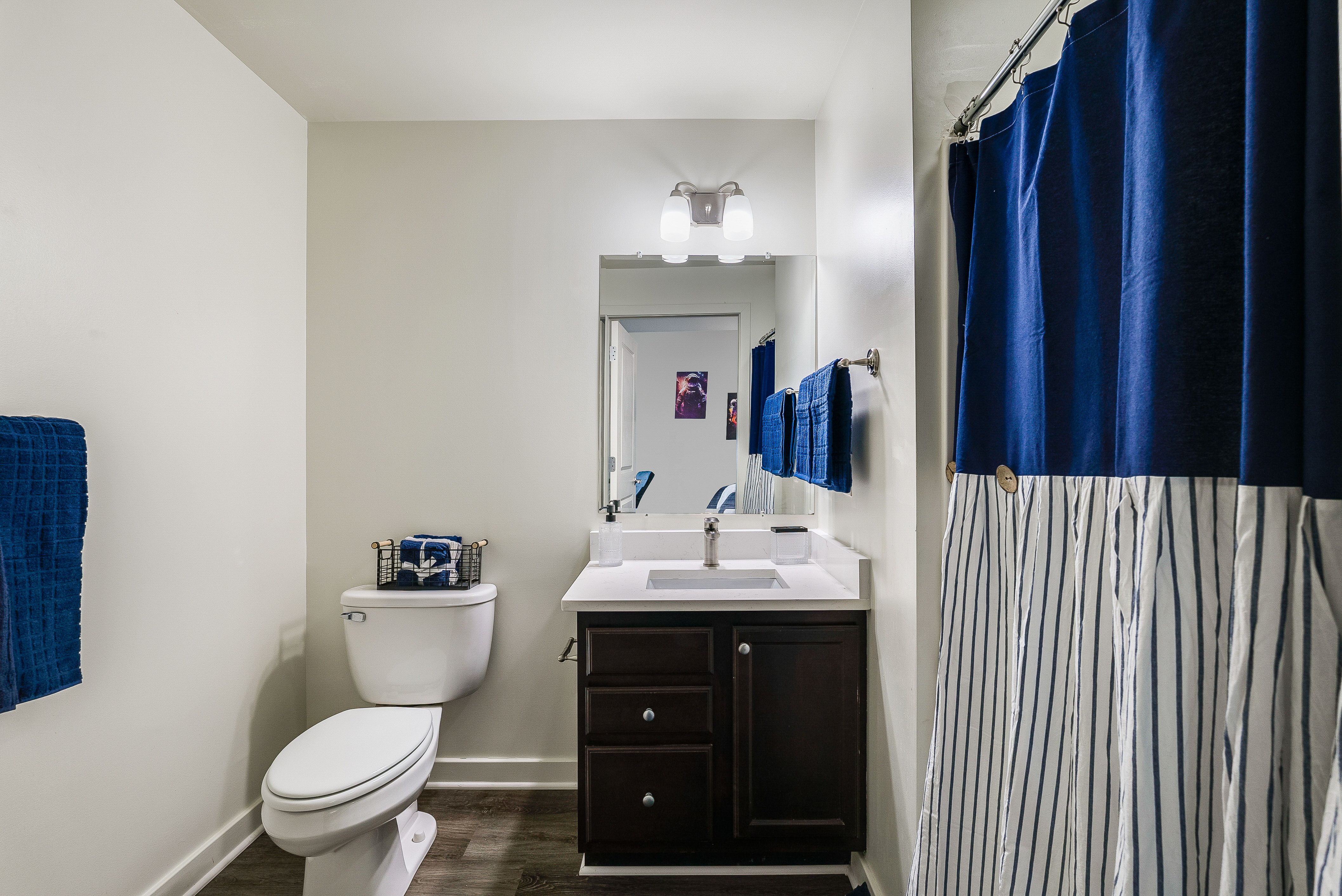 Bathroom with tub with shower curtain and vanity 