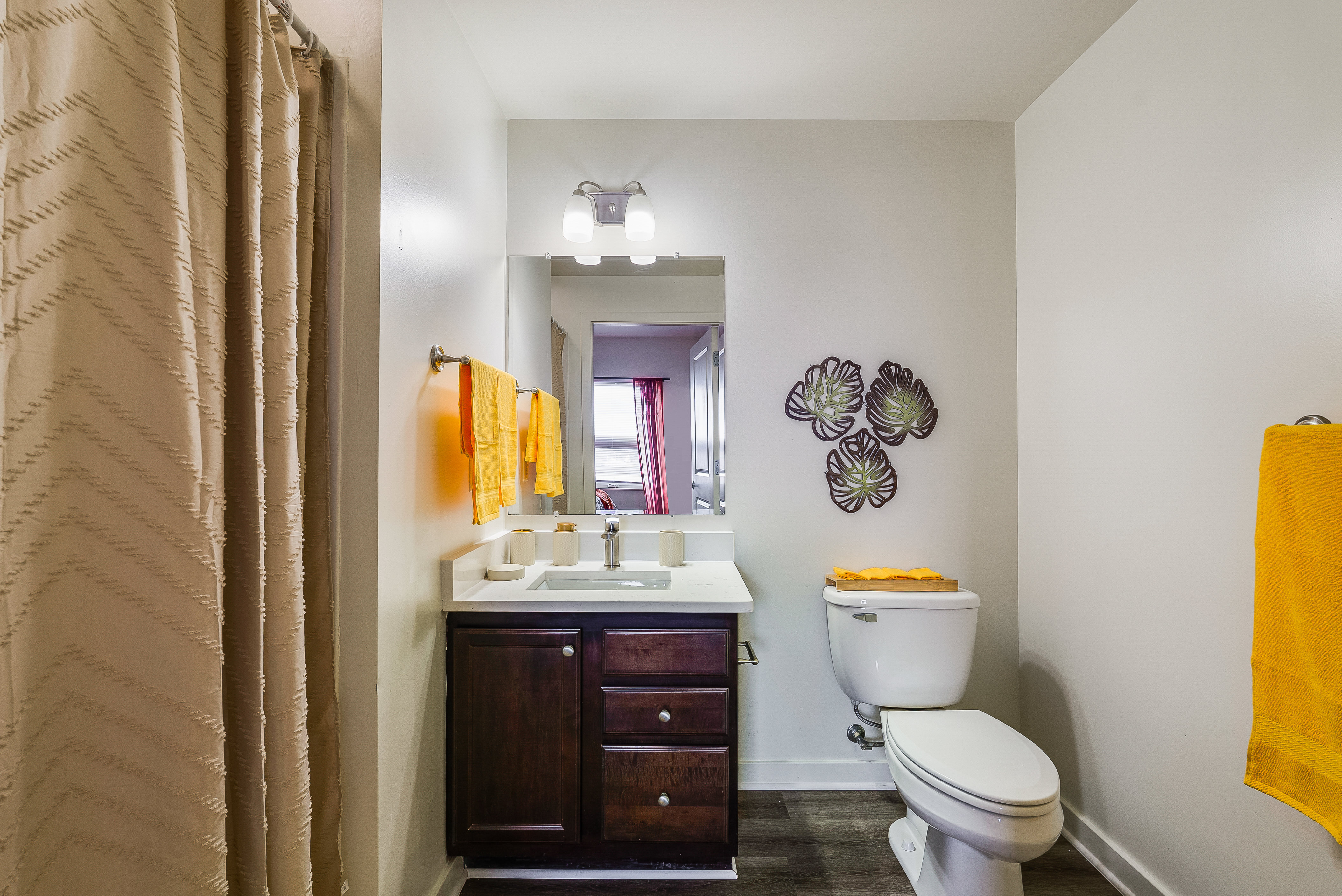 Bathroom with tub with shower curtain and vanity 