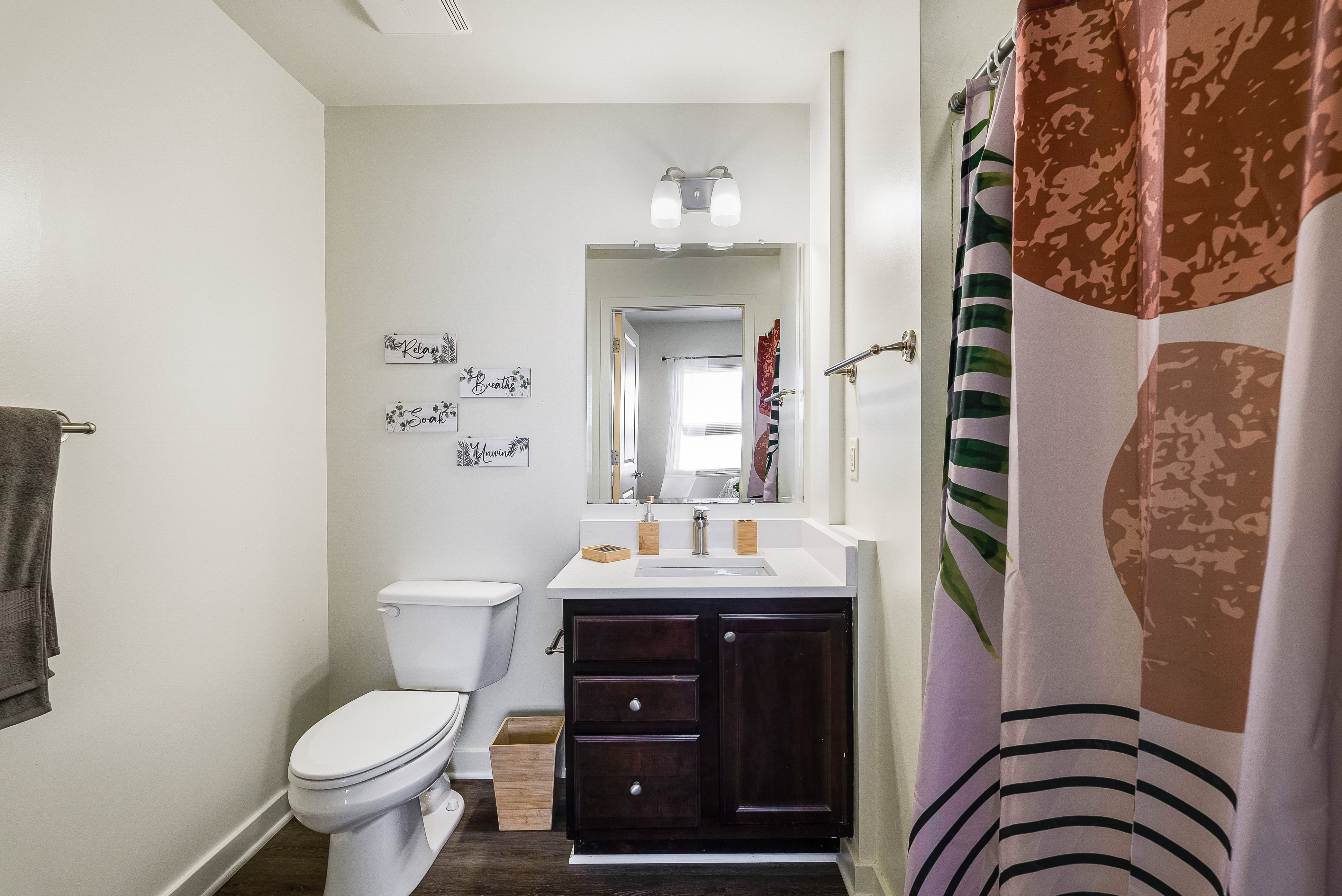 Bathroom with tub with shower curtain and vanity 