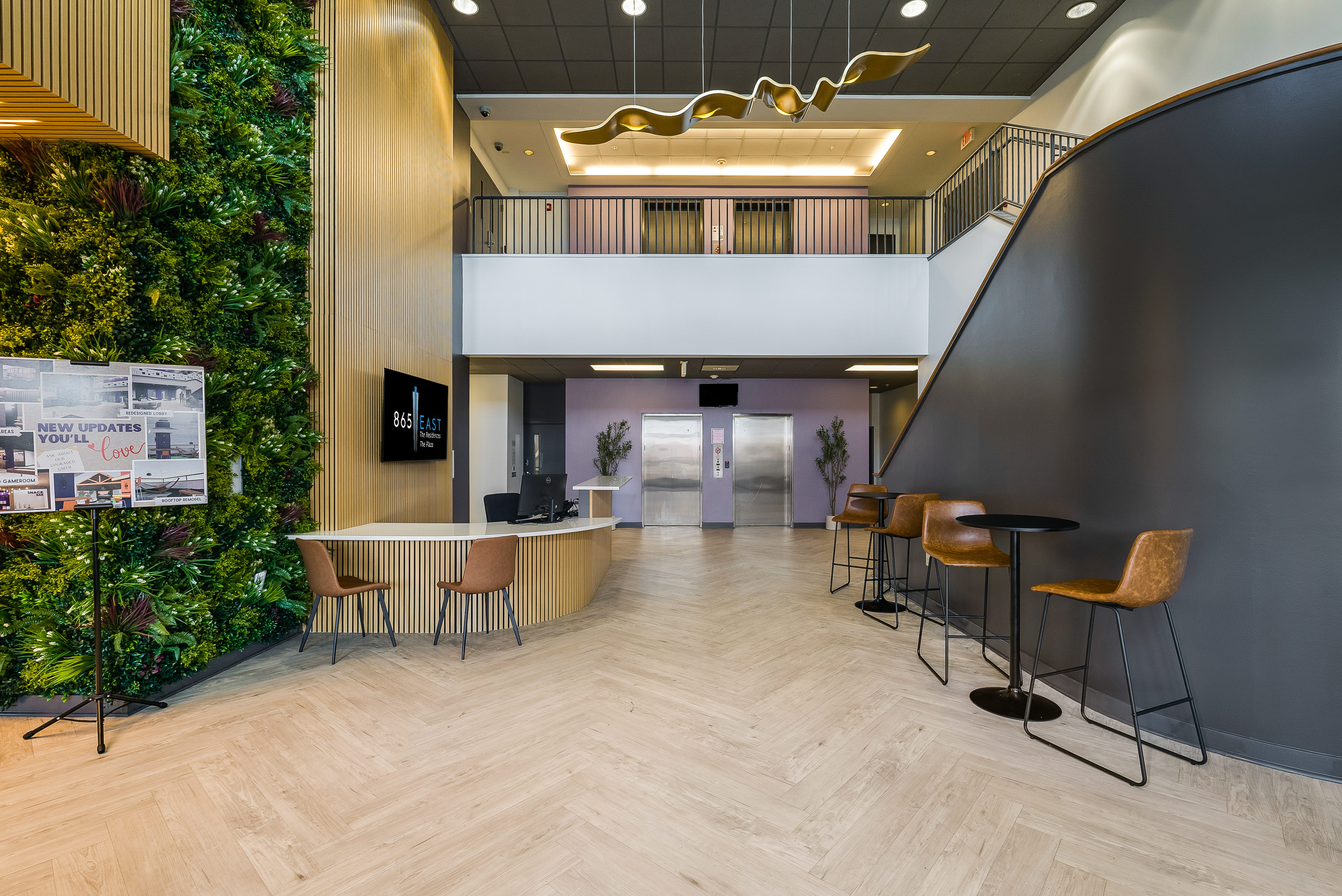 Leasing office with desk, tables, and chairs with view of elevators