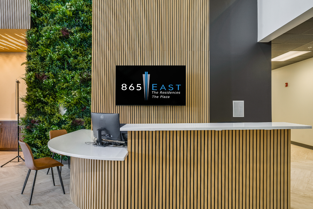 865 East Lobby with desk, chairs, and tv