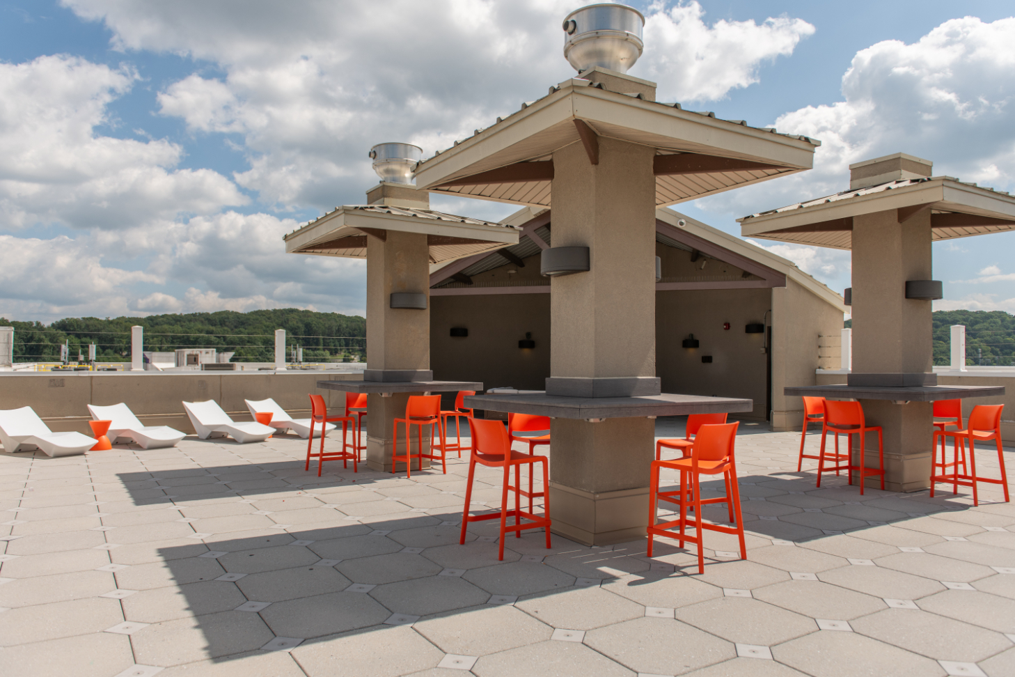 Outdoor lounge area with covered seating and lounge chairs