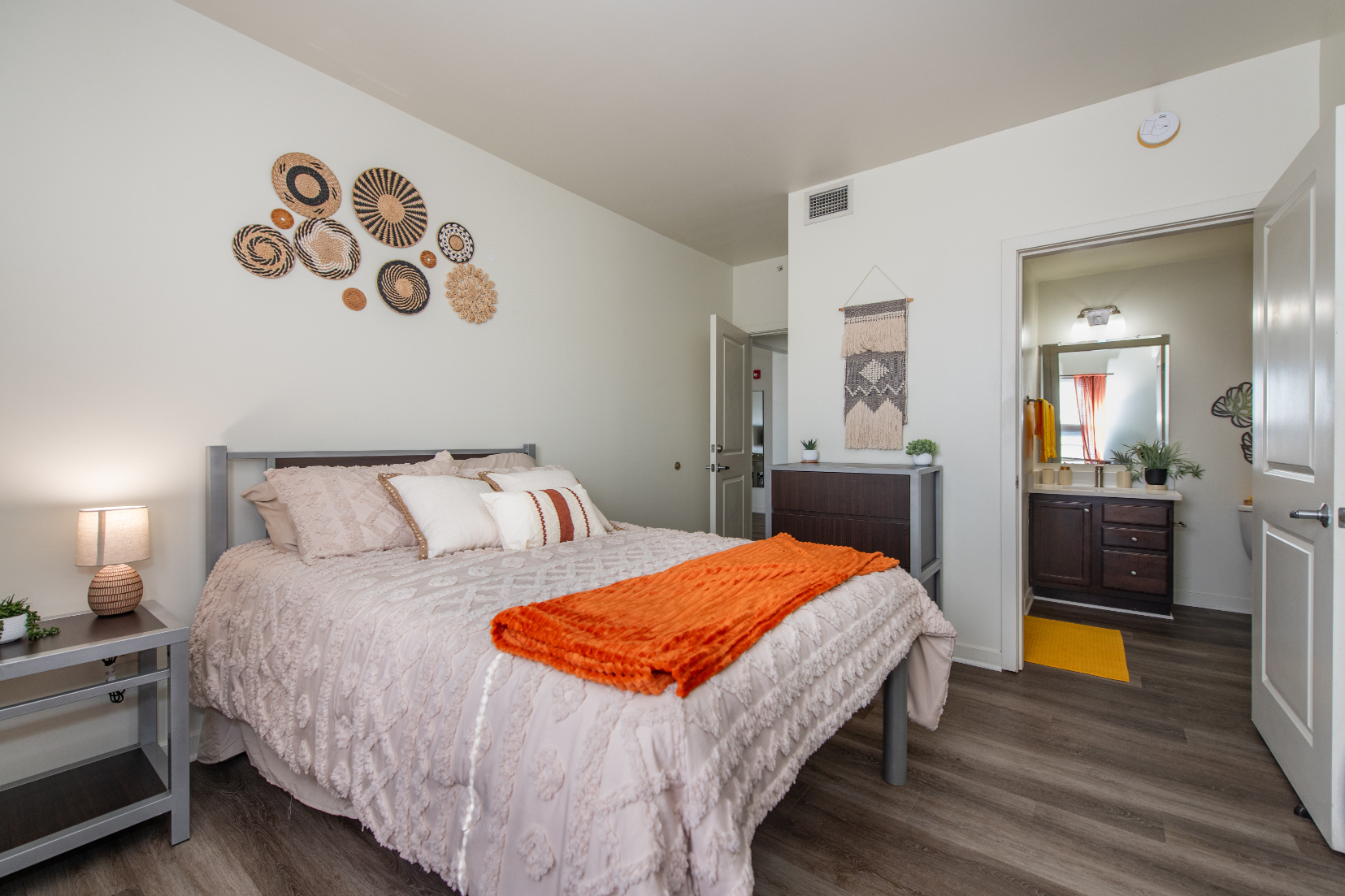 Bedroom with bed and view into bathroom