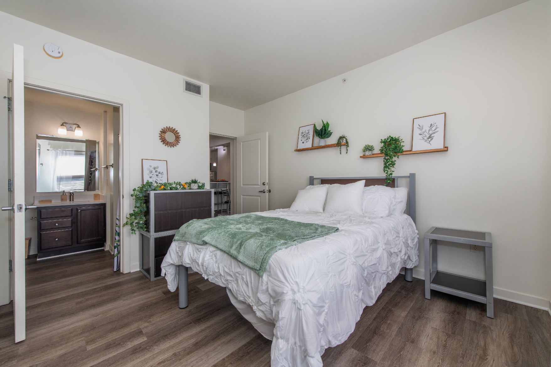 Bedroom with bed and view into bathroom