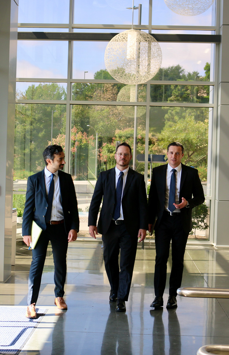 Two attorneys in suits walking down stairs at the San Diego County Courtroom