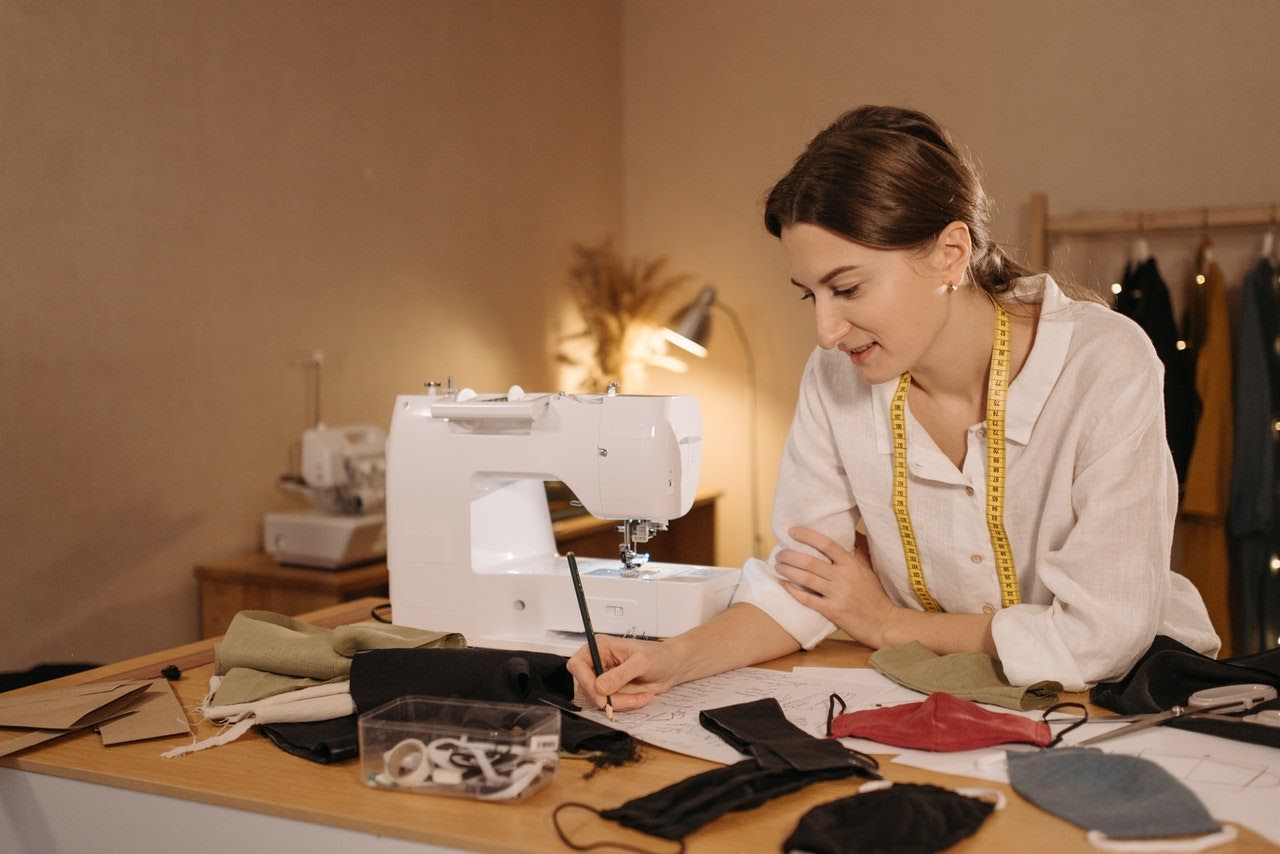a woman with a sewing machine manufacturing a product