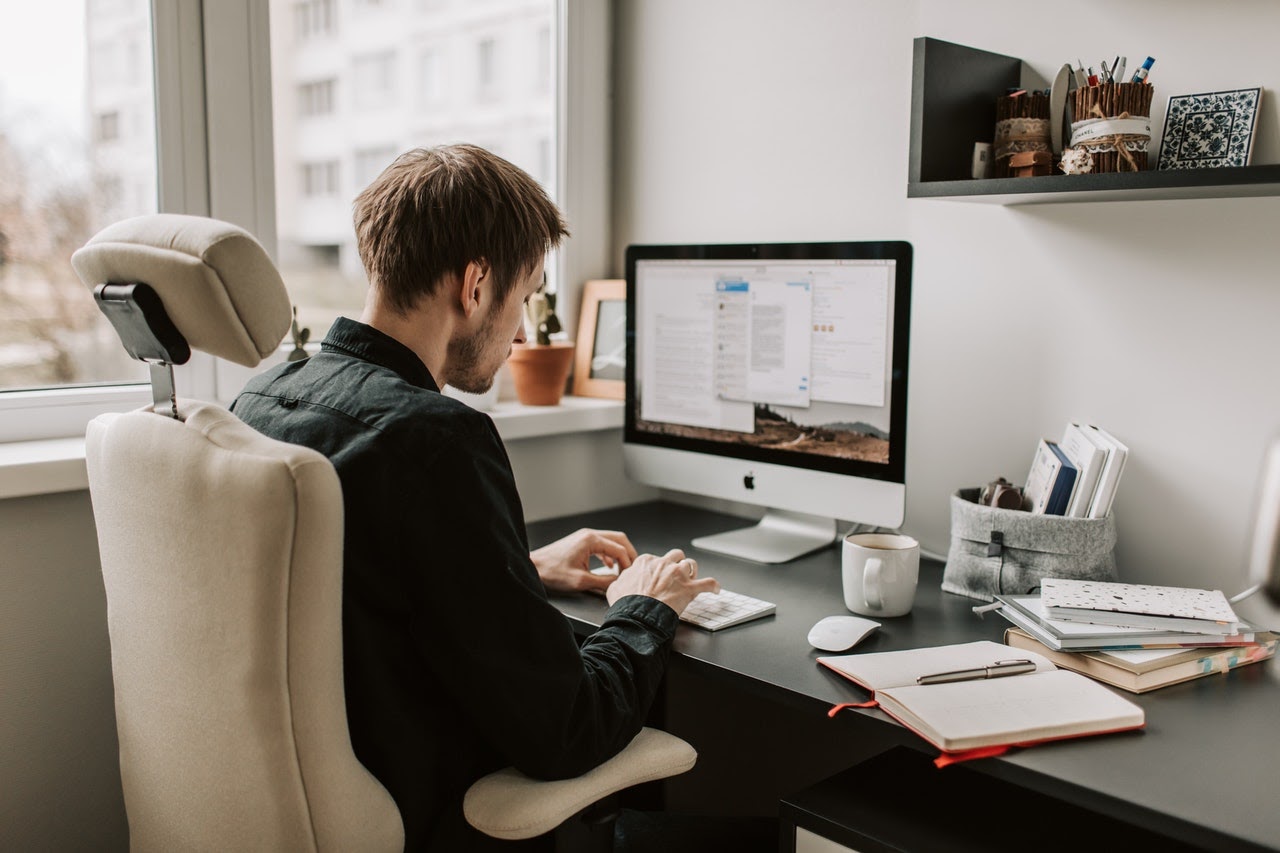 a man drafting blog content on his computer