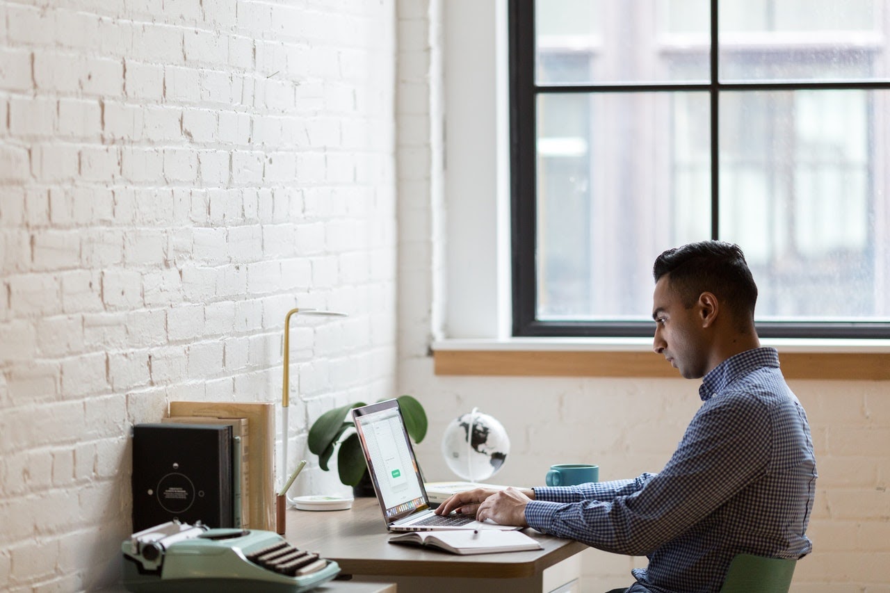 a man creating a content calendar for his blog on his laptop