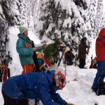 Skinning up as Jeff debriefs downhill guiding techniques.