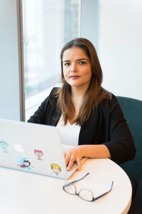 Woman sitting in front of a computer.