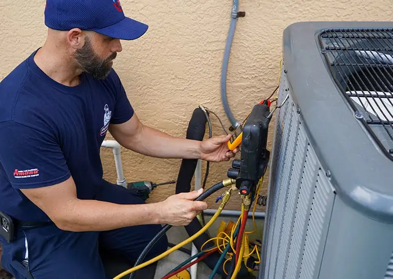 Technician performing maintenance on an air conditioning unit, using tools and gauges to ensure optimal performance and reliability in HVAC service.