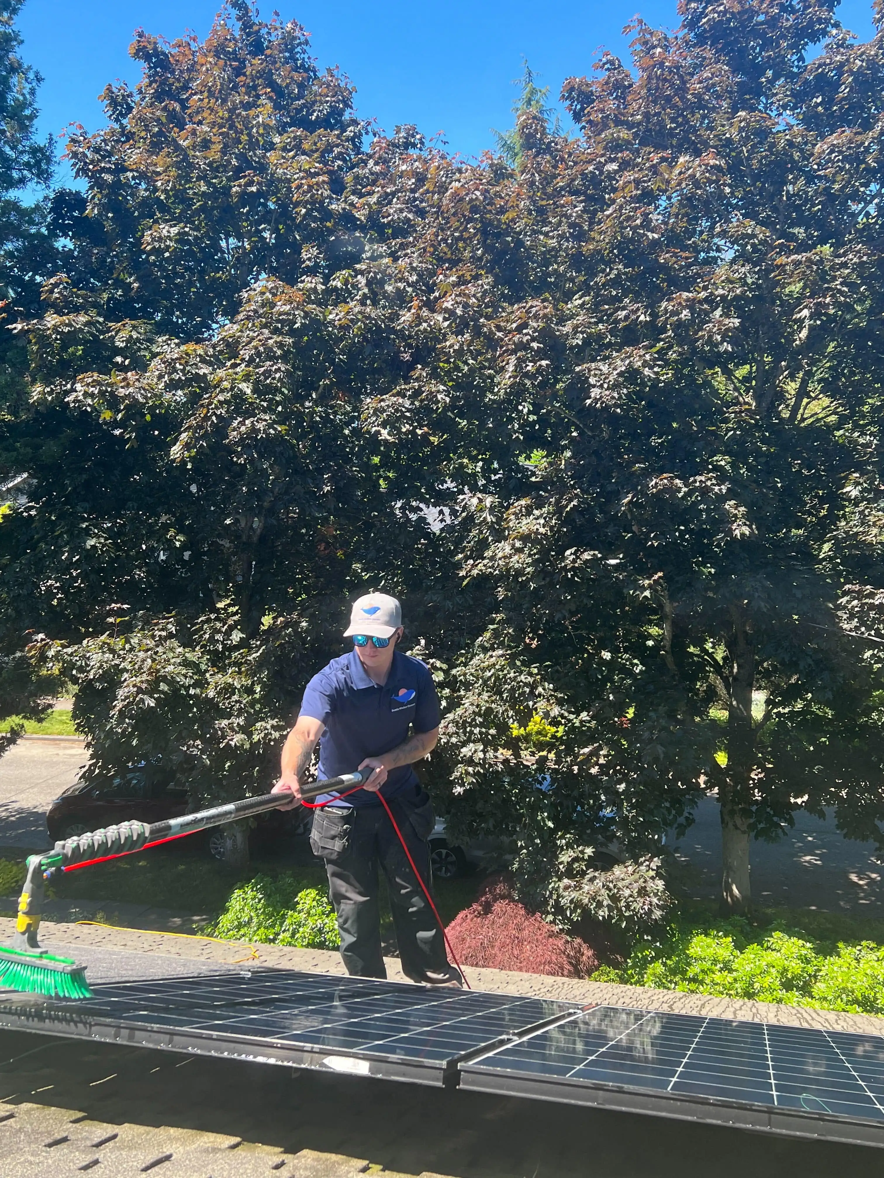 residential window cleaning near me in Seattle, WA with technician using squeegee on large patio doors