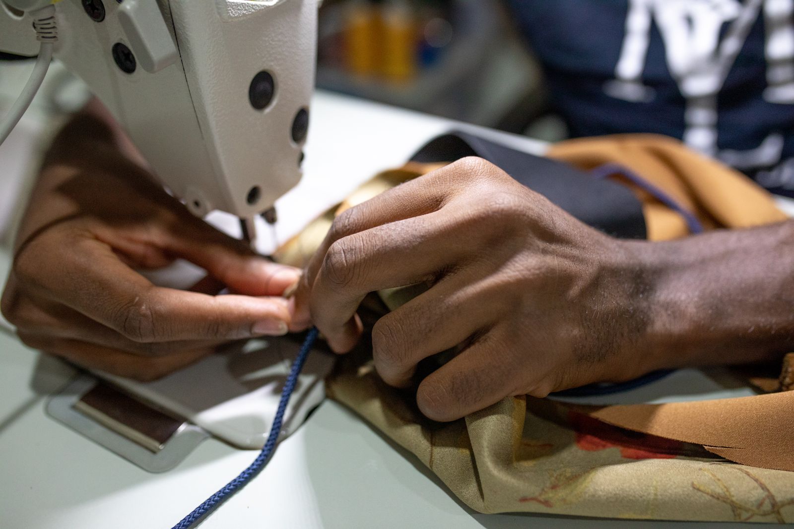T-shirt fabric being sewn on an industrial sewing machine in Istanbul