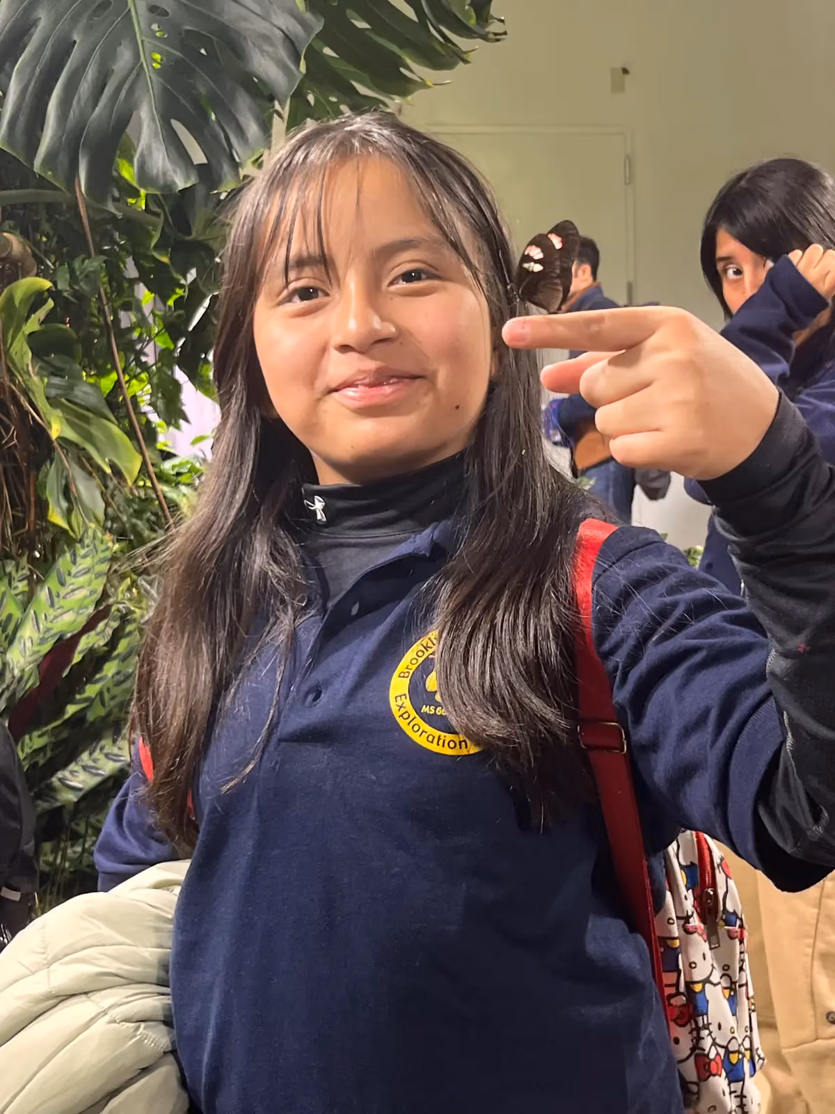 Student in Brooklyn Exploration school uniform smiling on field trip