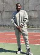 Mr. Allen Jones smiling on outdoor basketball court