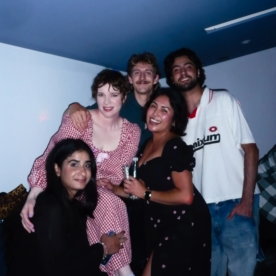 Emily, Cole, Omar, Catherine, and Sarah, our team members, pose for a group photo at Karaoke night